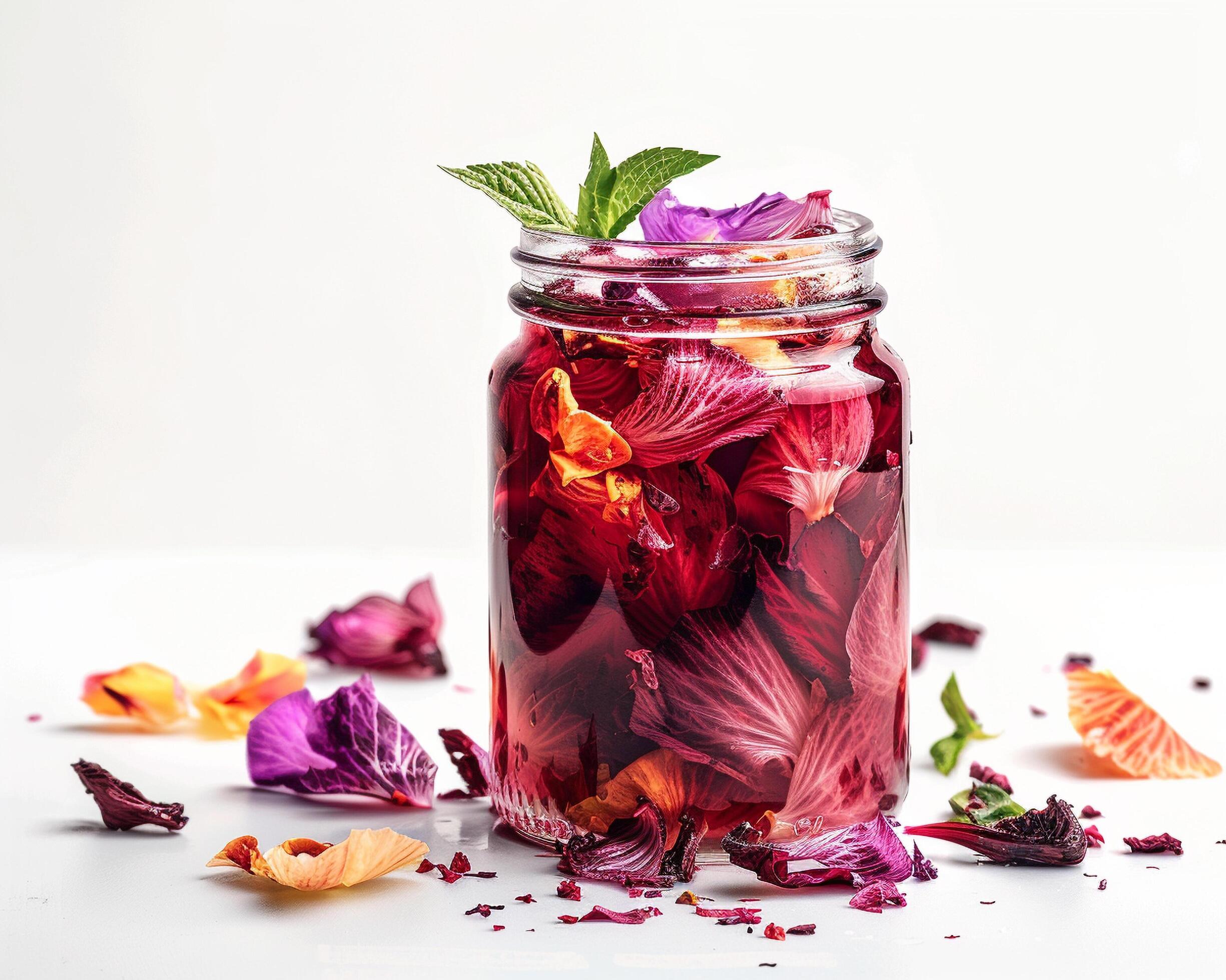 a jar filled with red flowers and leaves Stock Free