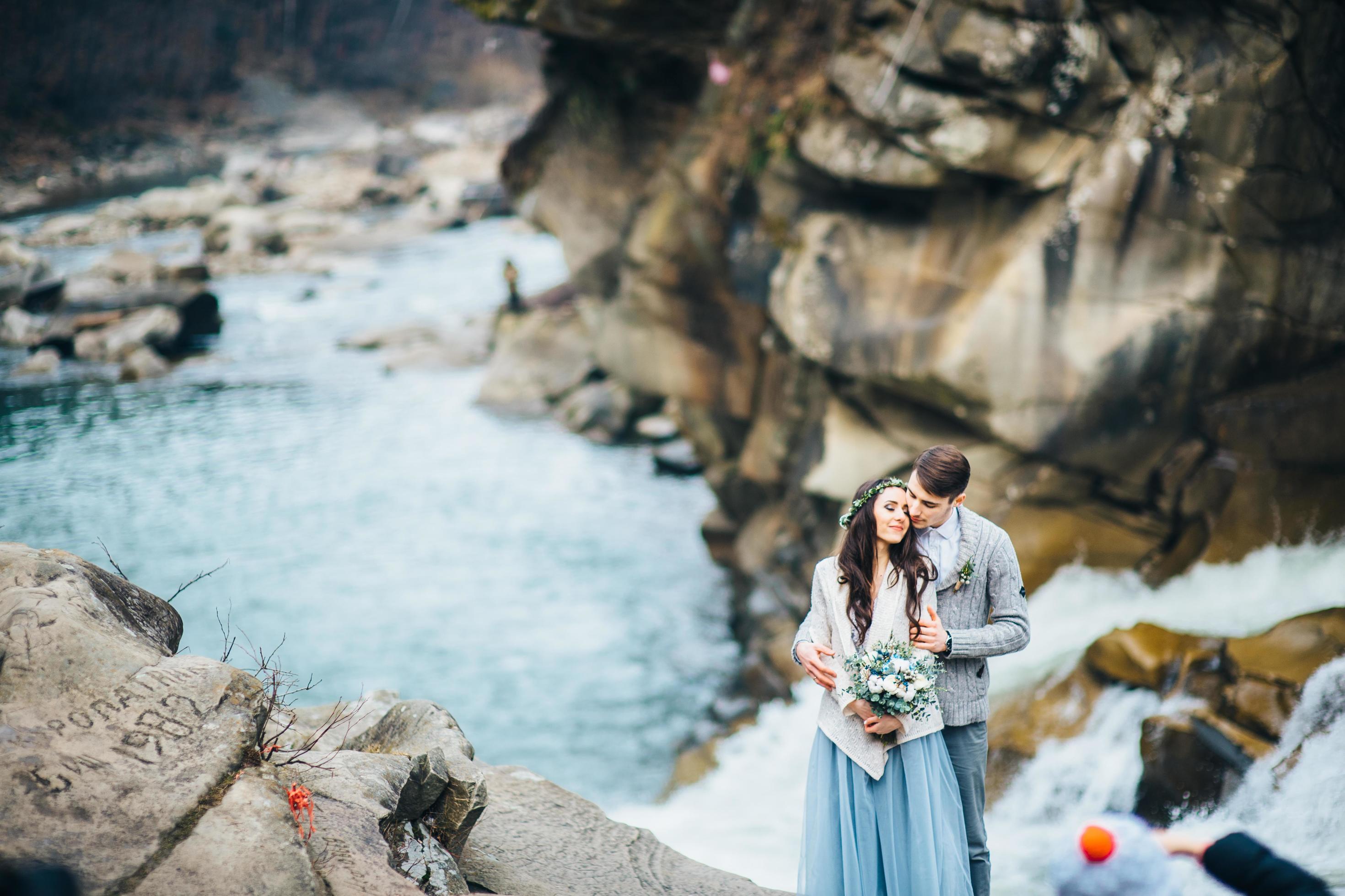 Young couple in love on a mountain river Stock Free