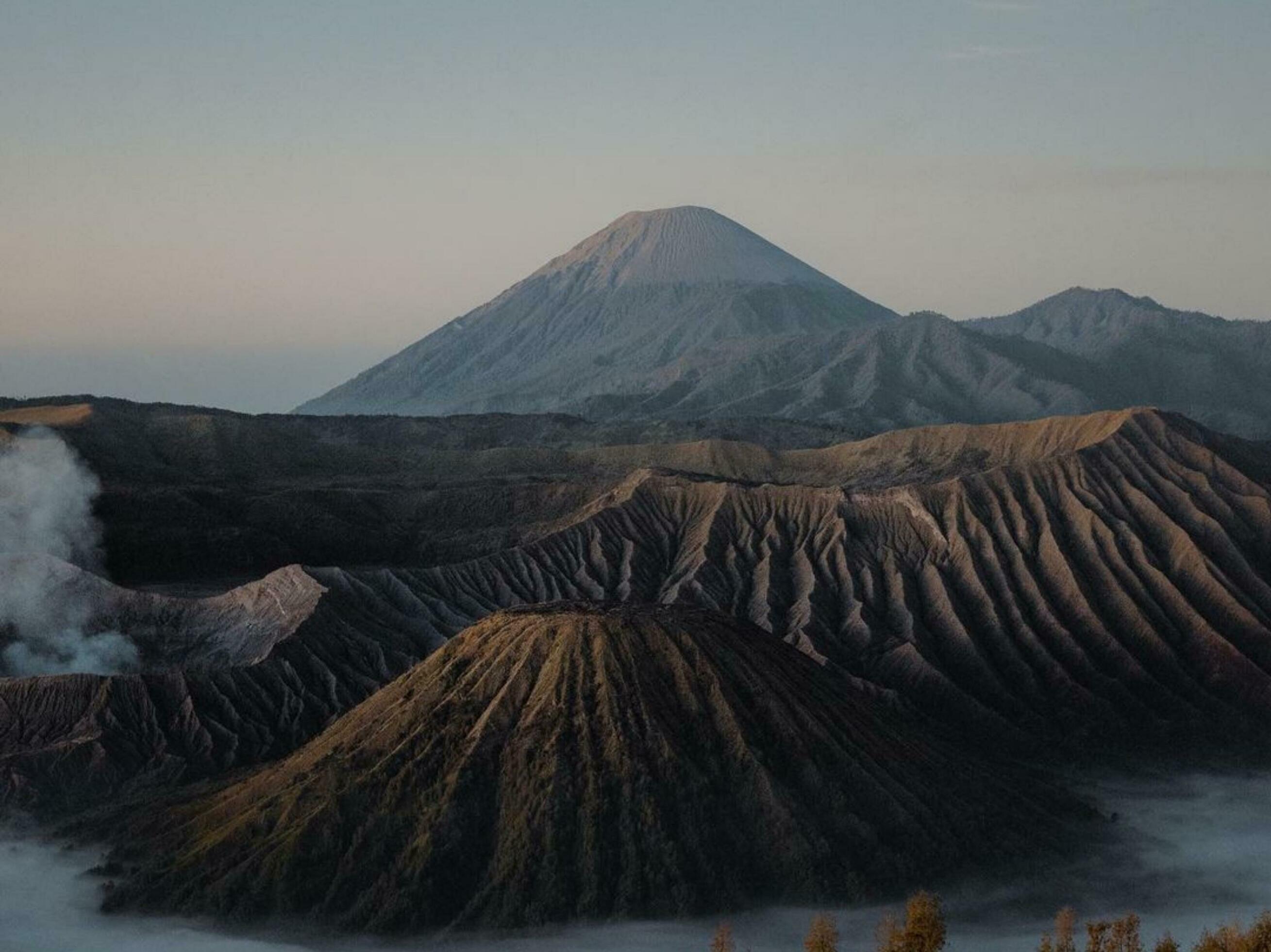 Raw Power Majestic Volcano Amidst Pristine Wilderness Active volcano in wilderness, showcasing raw beauty of nature, with cinder cone and smoke. Stock Free