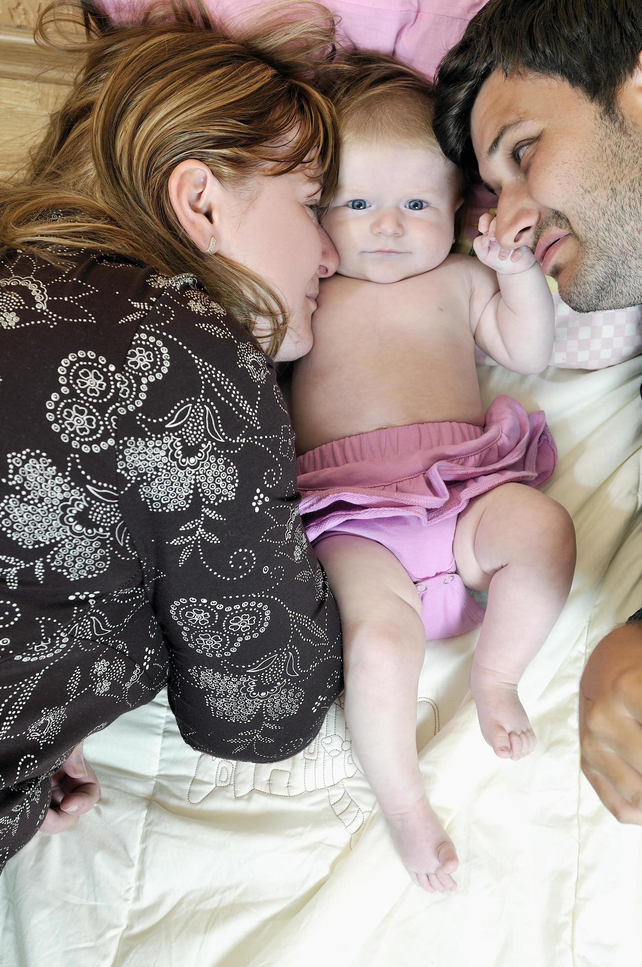 portrait of young family with cute little babby Stock Free