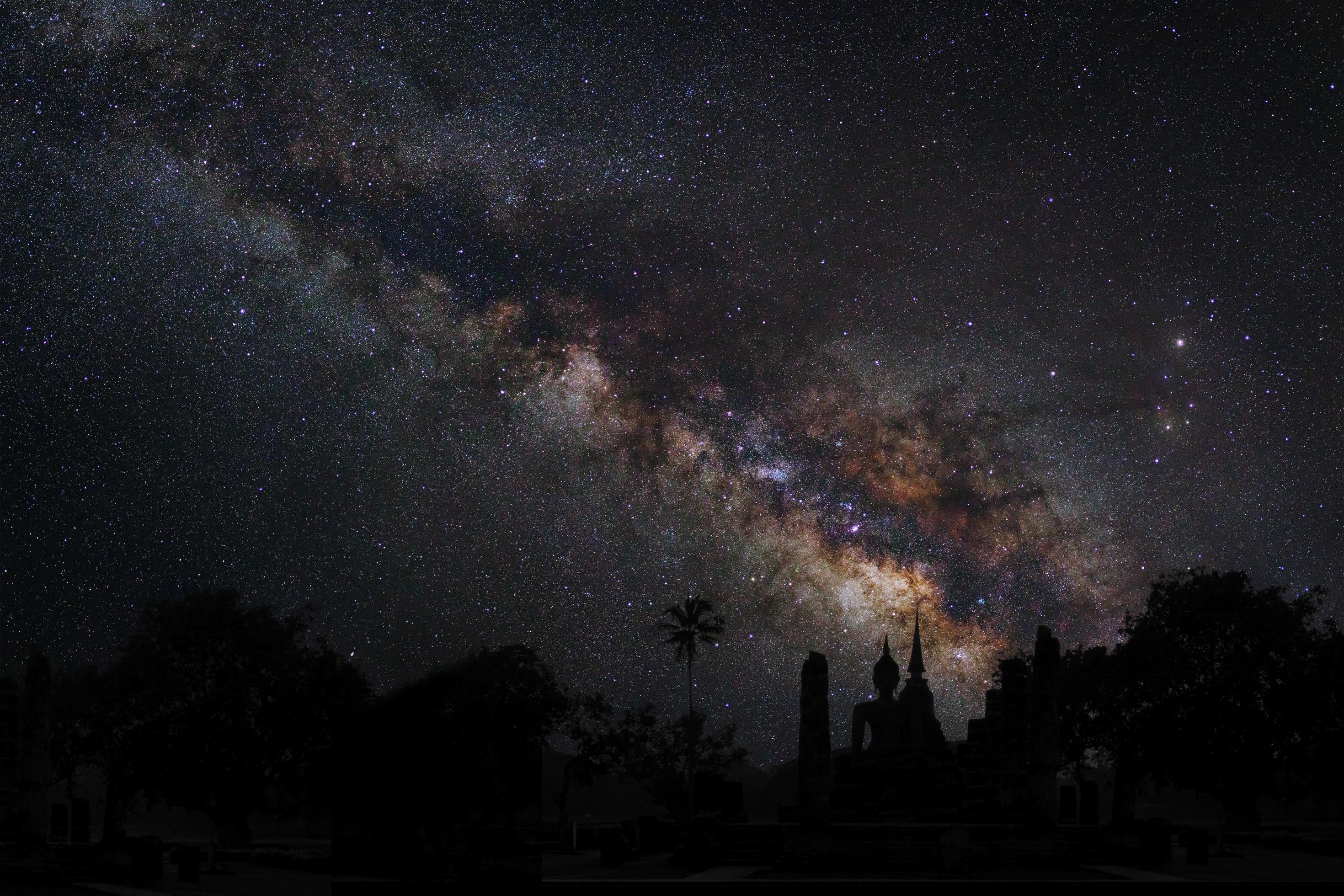 Landscape with milky way, Night sky with stars and silhouette of temple, Long exposure photograph, with grain Stock Free