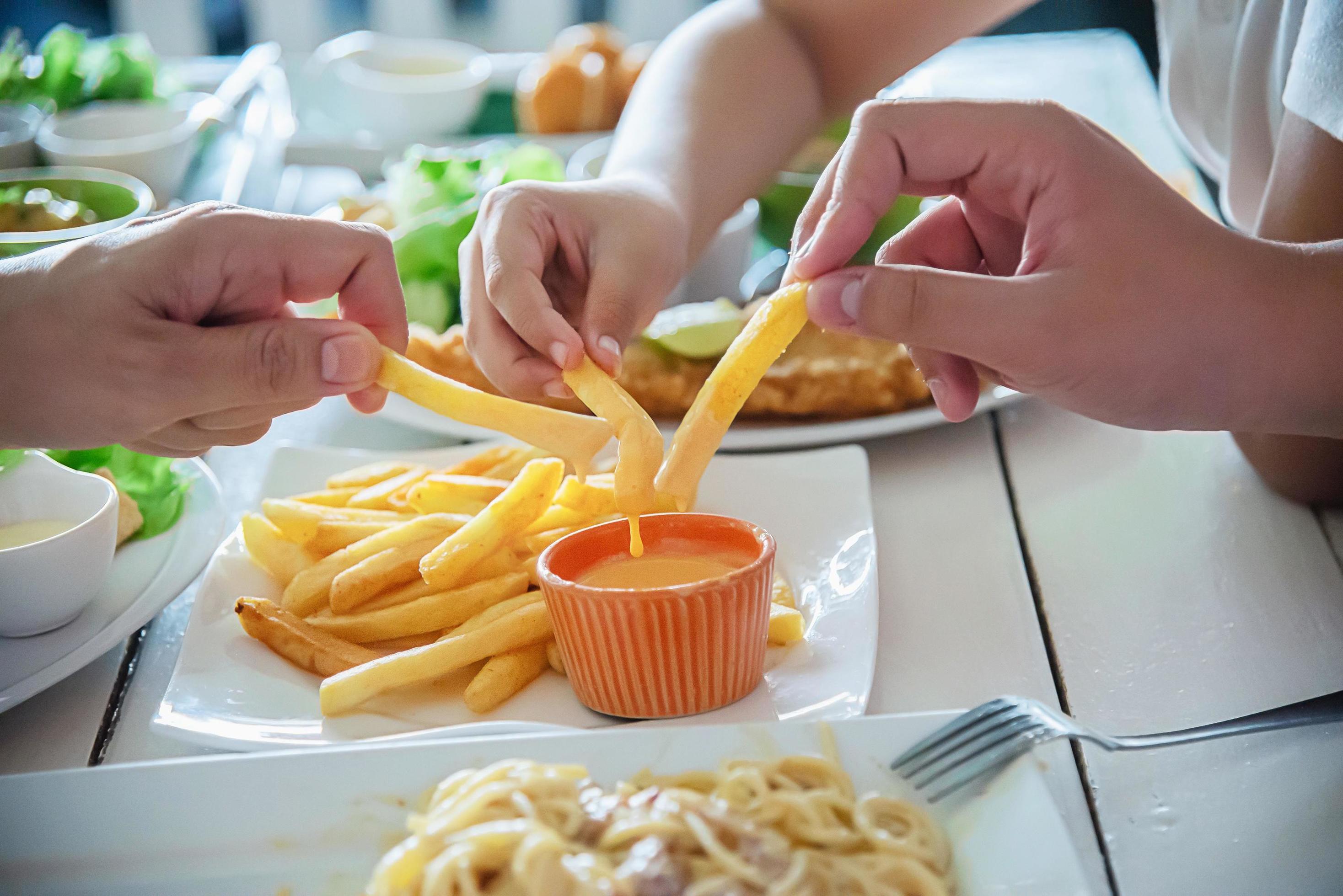 Family time eat French fries together – family life with food concept Stock Free