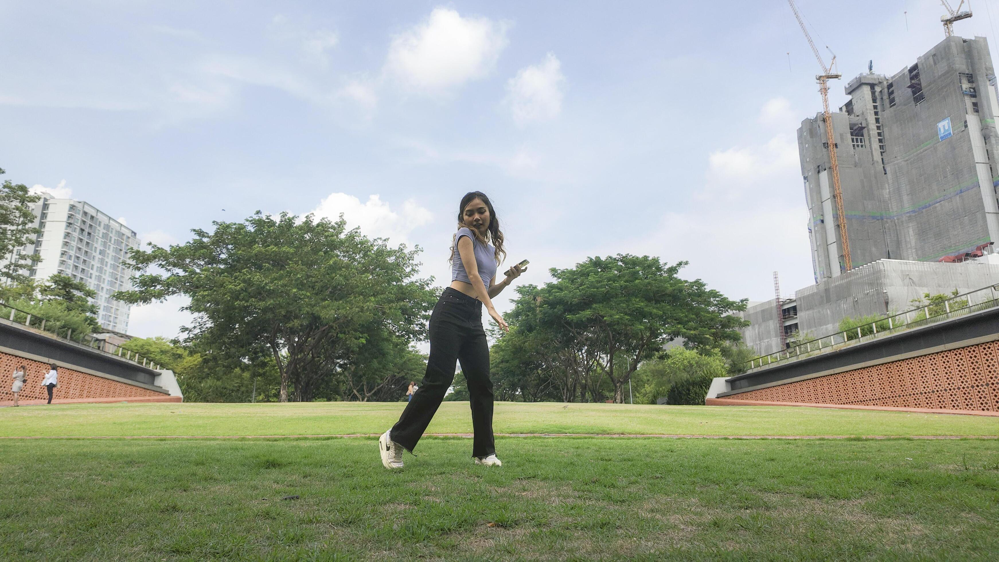 Asian women do freestyle hip hop and breakdancing in a public space in the middle of the city. With a cheerful and happy attitude Stock Free