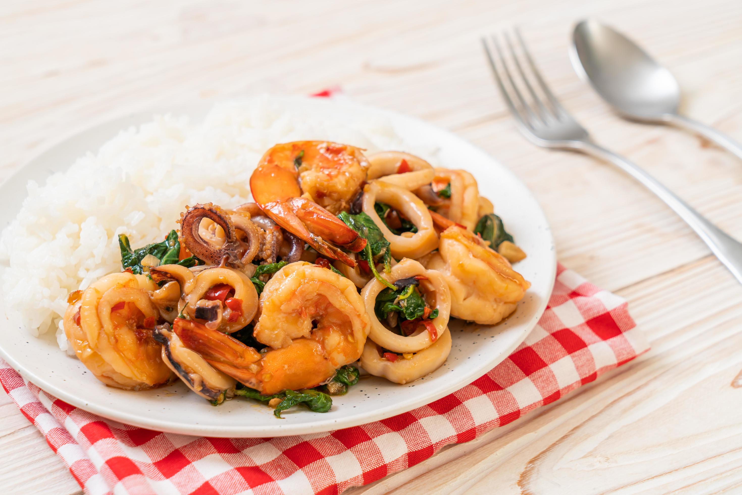 Rice and stir-fried seafood of shrimp and squid with Thai basil – Asian food style Stock Free