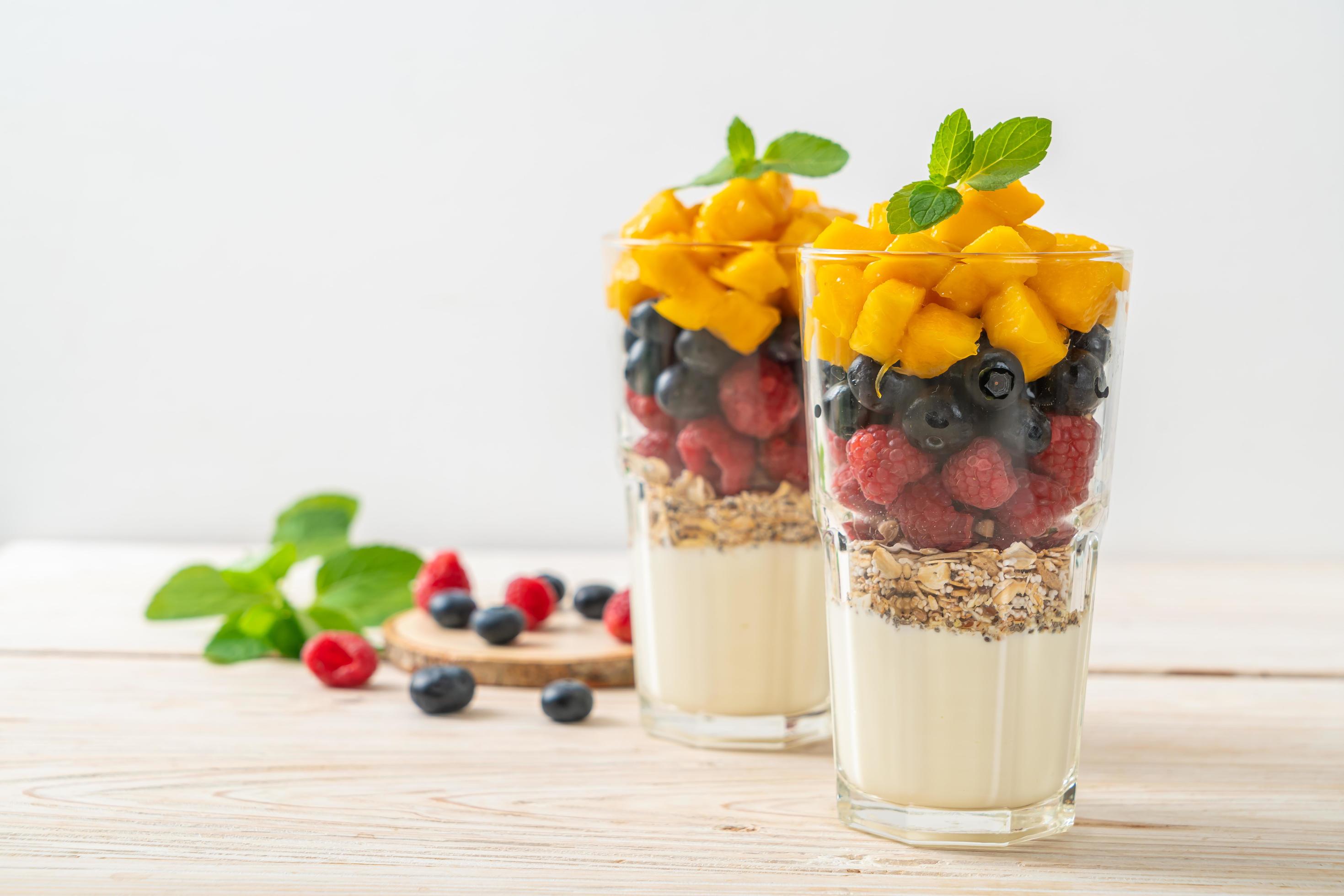 Homemade mango, raspberry, and blueberry with yogurt and granola – healthy food style Stock Free