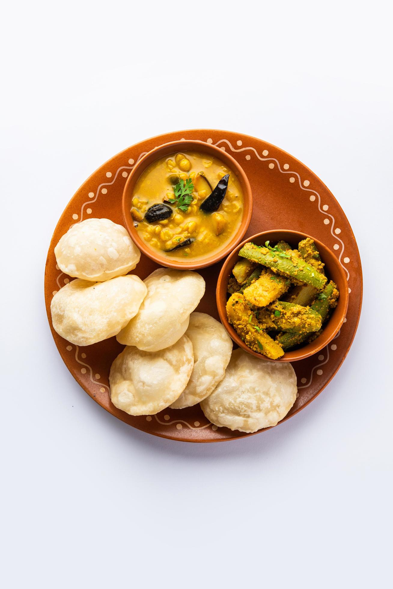 Cholar dal and patol aloo sabzi served with fried Luchi or poori, bengali food Stock Free