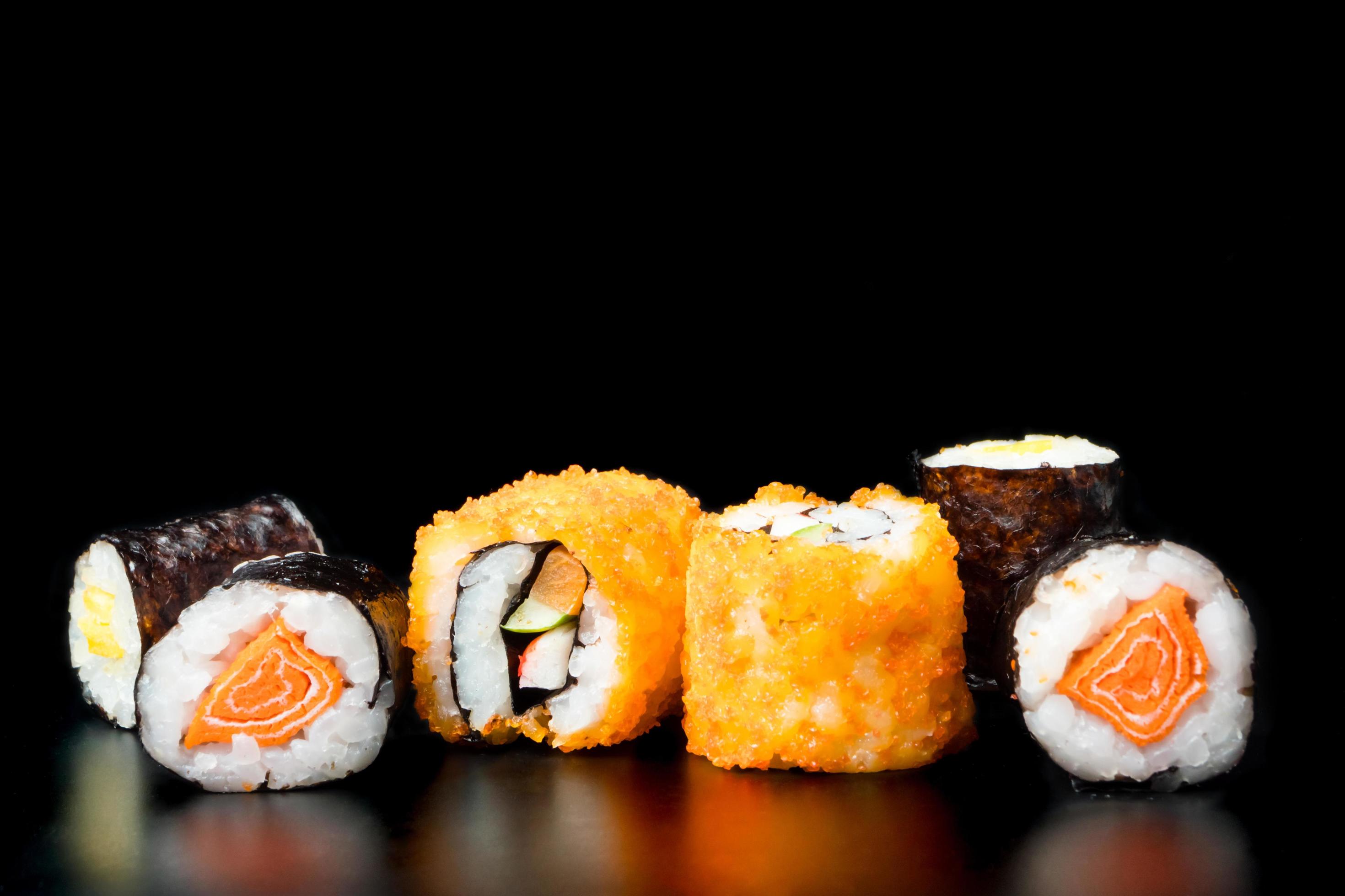 Sushi rolls on black background, Japanese food. Stock Free