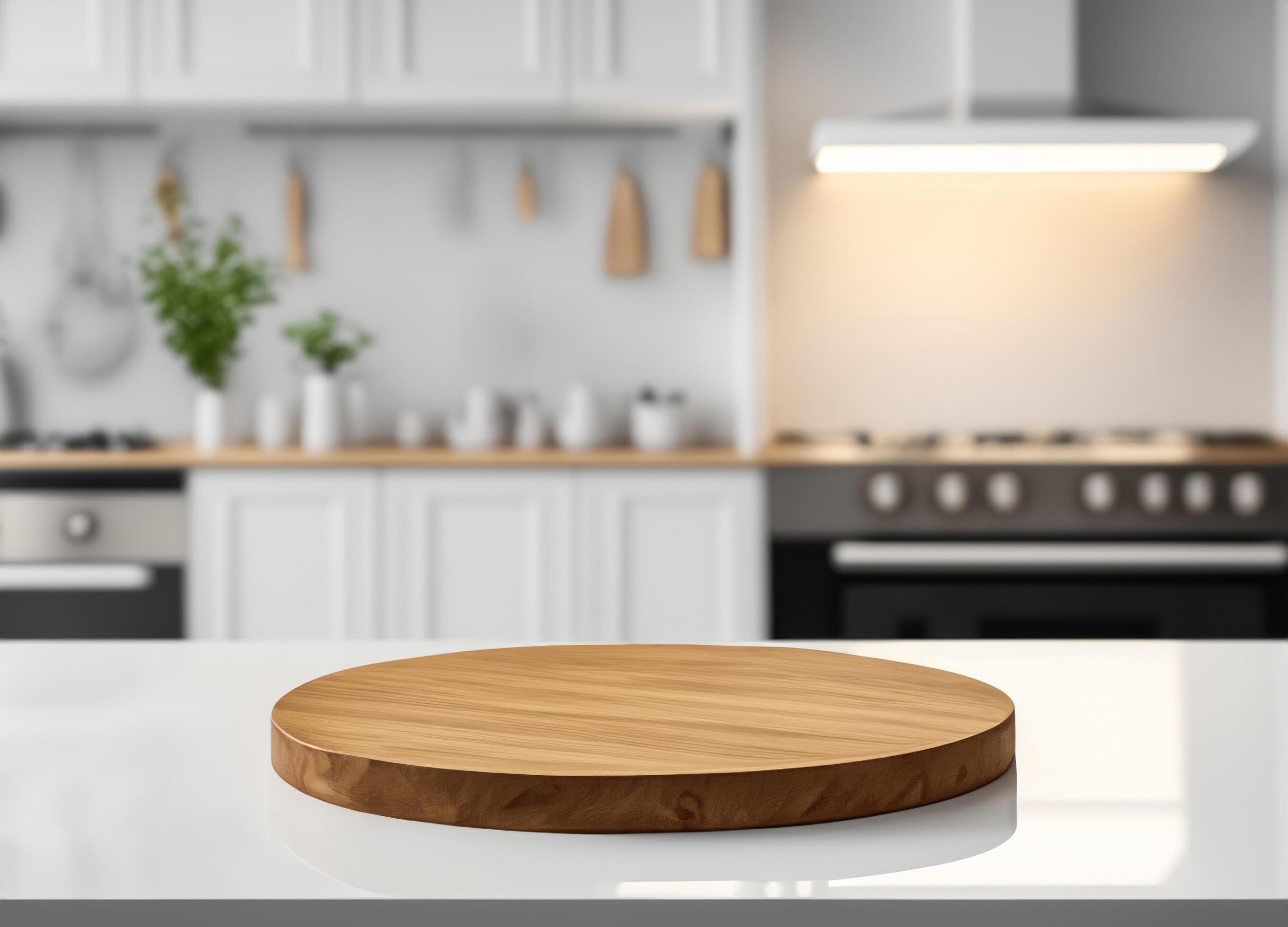 Round wood cutting board with blurred modern interior kitchen Stock Free