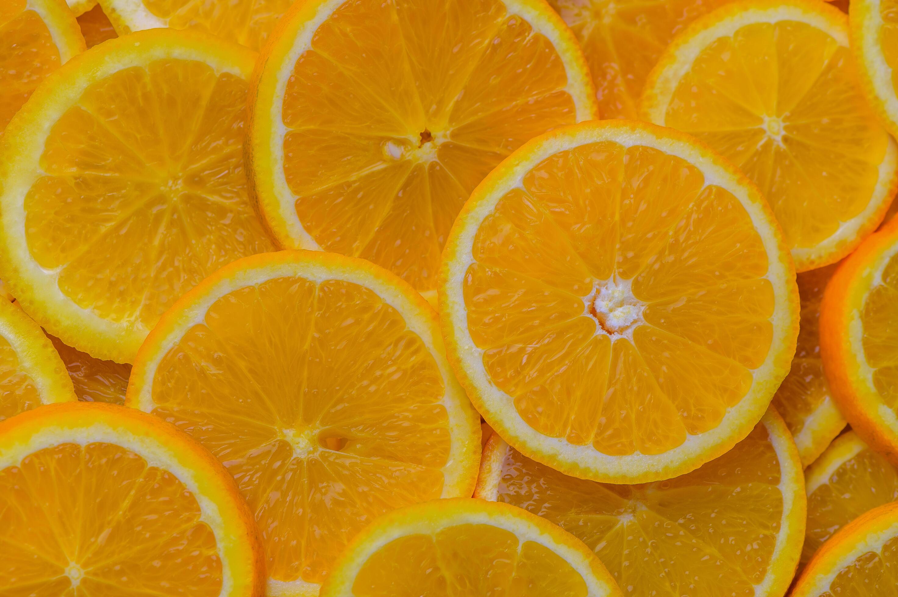 oranges cut into slices and laid out on the table as a food background 10 Stock Free