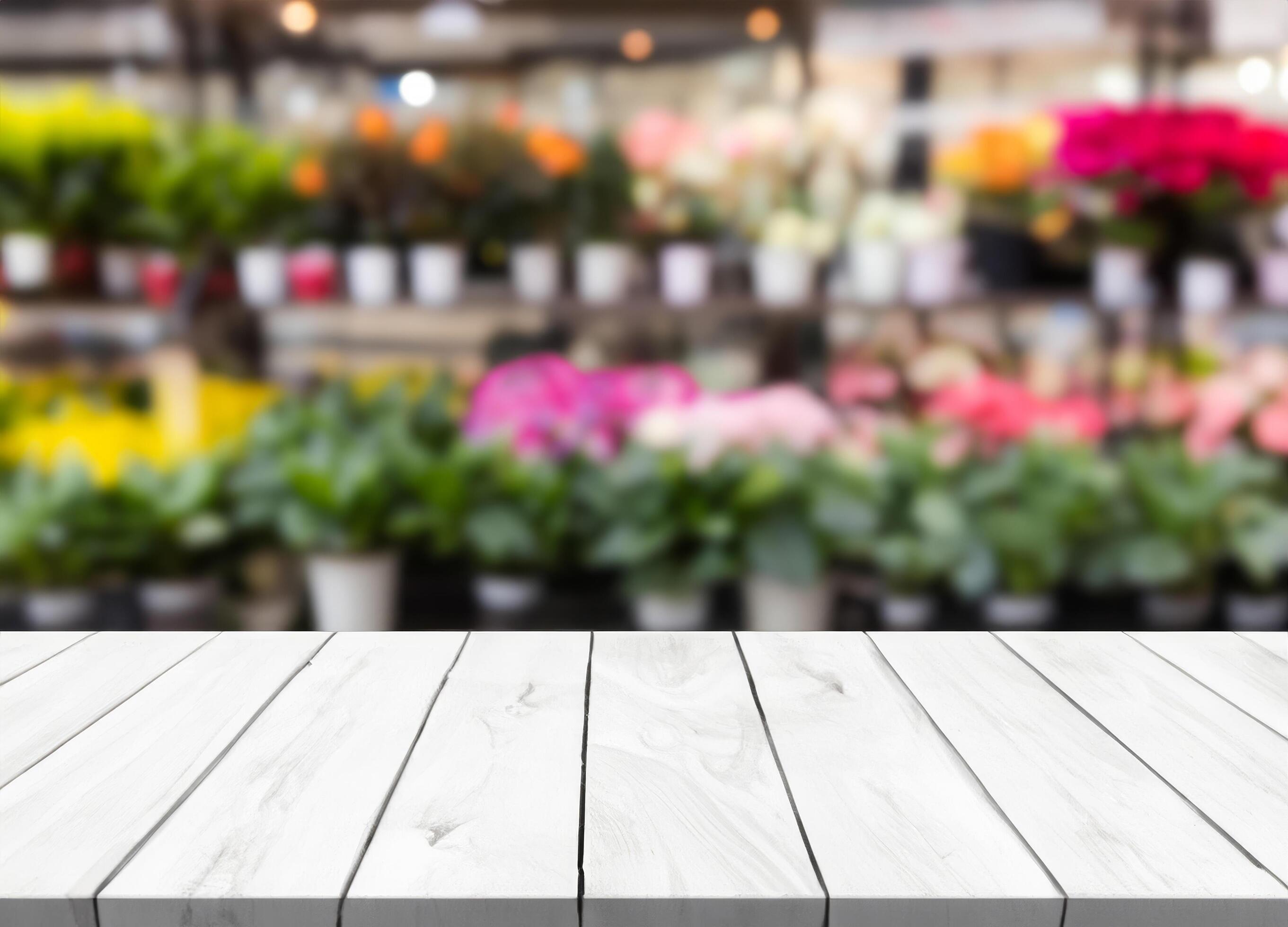 White wood table with blurred flower shop Stock Free