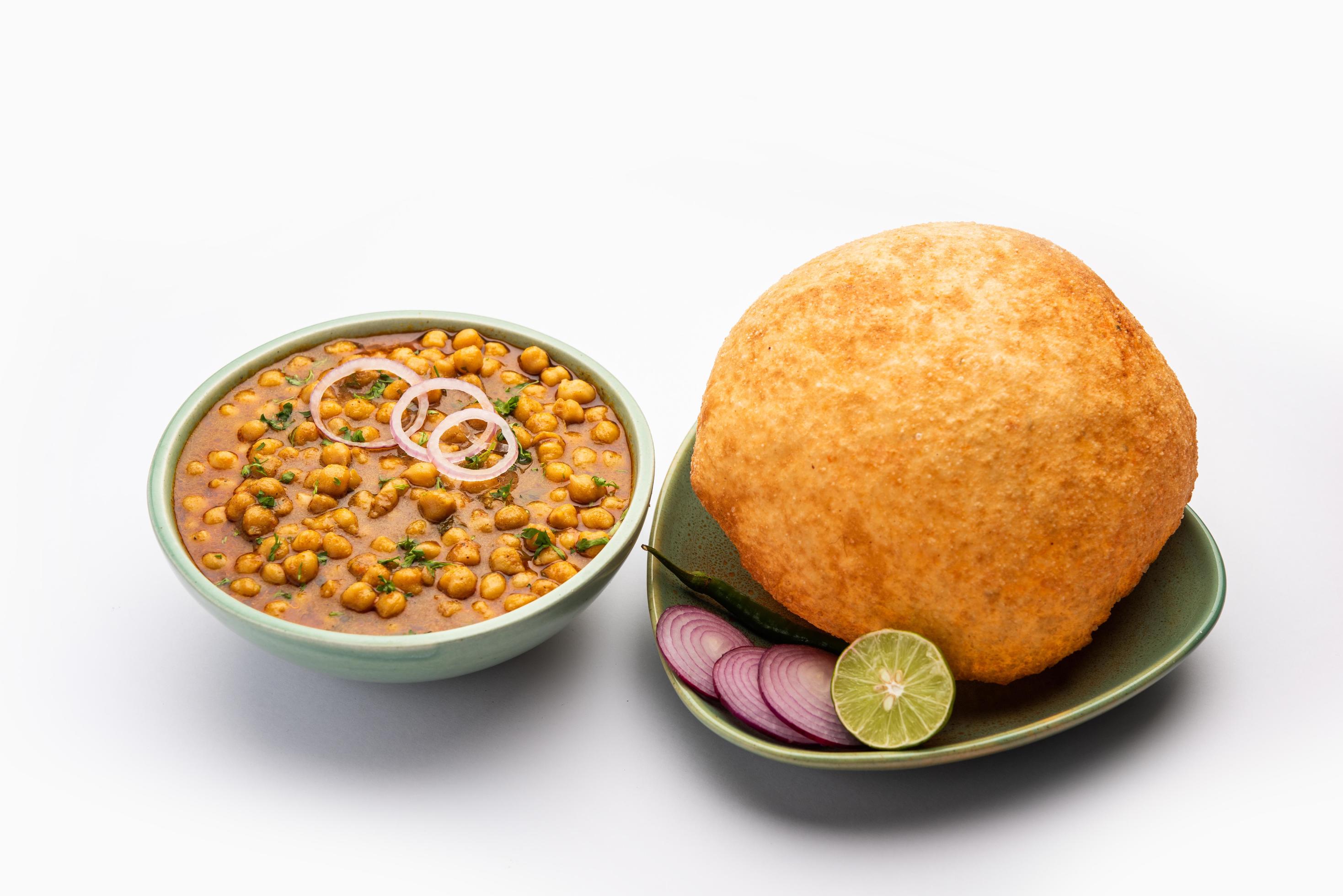 Chole bhature is a North Indian food dish. A combination of chana masala and bhatura or puri Stock Free