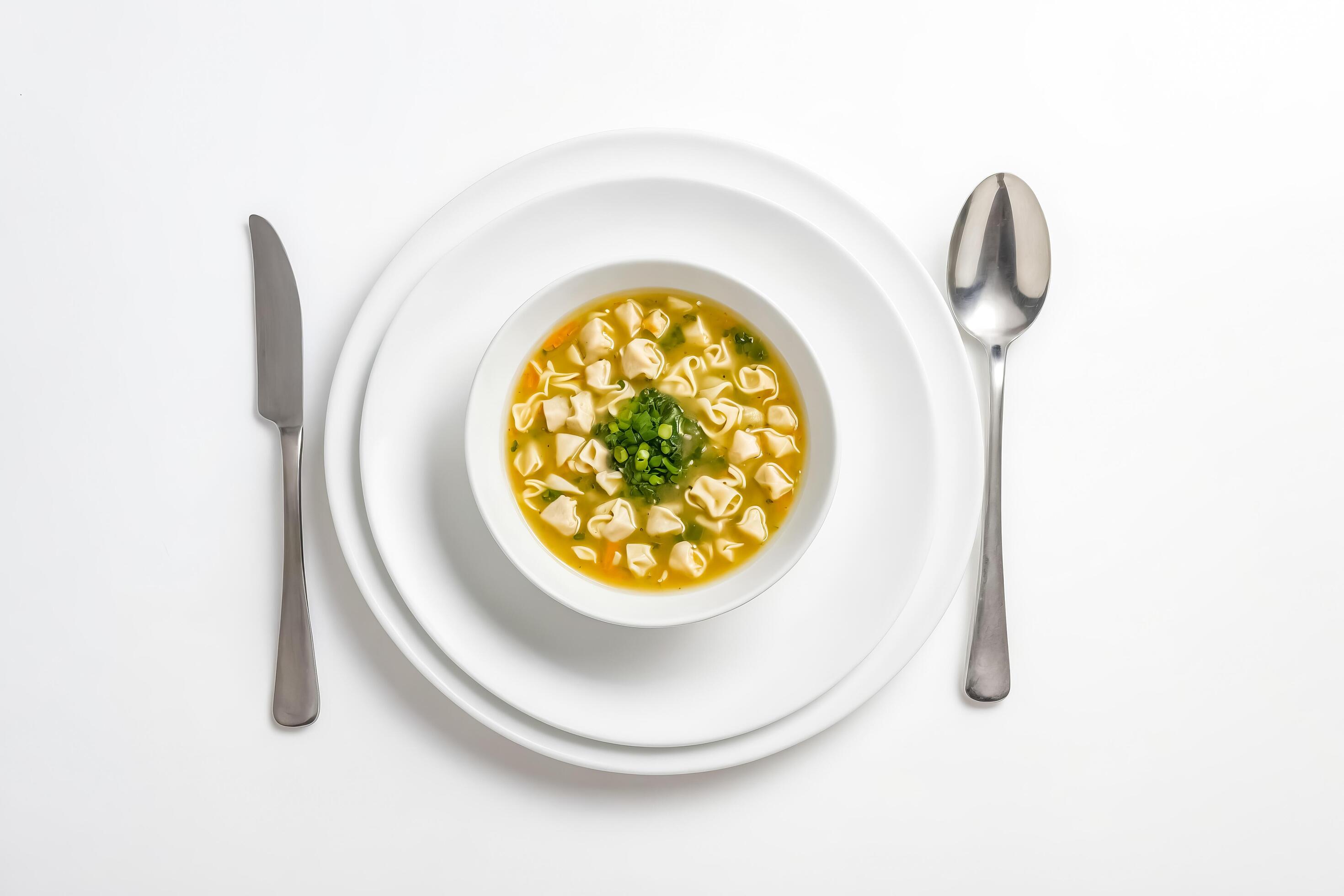 Top view of a bowl of soup with pasta and vegetables on a white background Stock Free