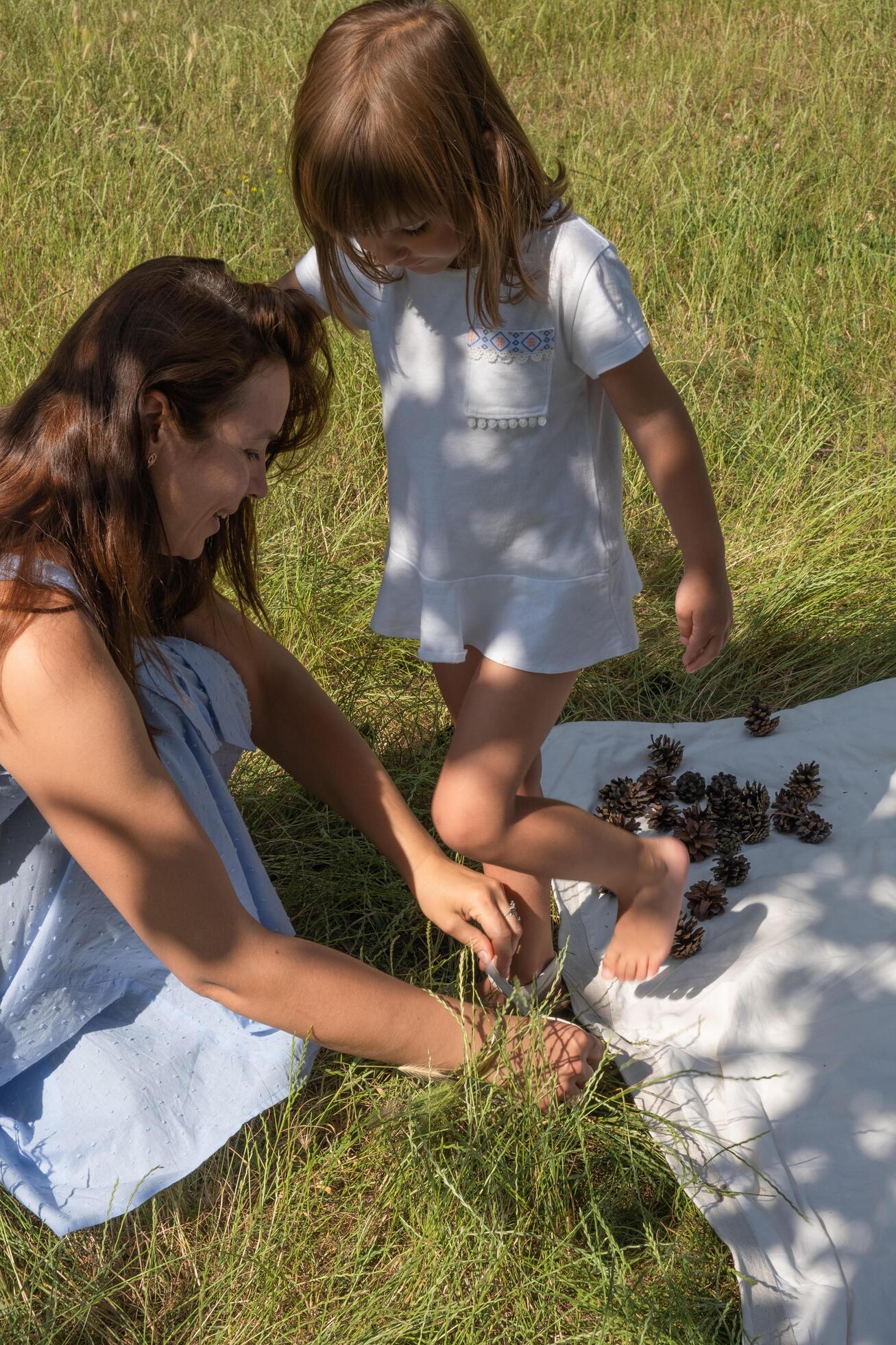 Mom and daughter having fun on a picnic. Family vacation in nature Stock Free