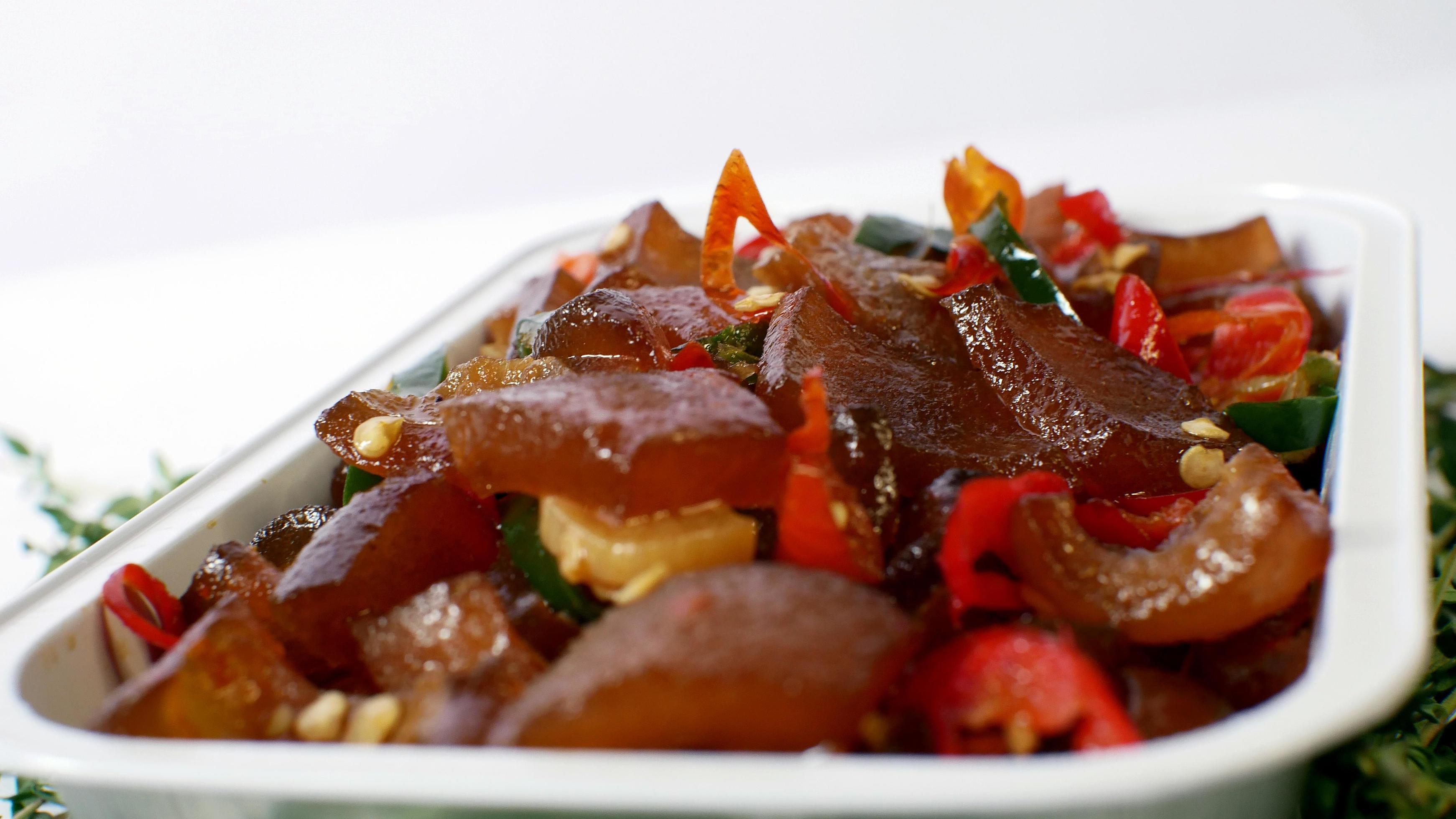 Stir-fried beef skin served in an aluminum place with typical Indonesian food on a white background Stock Free