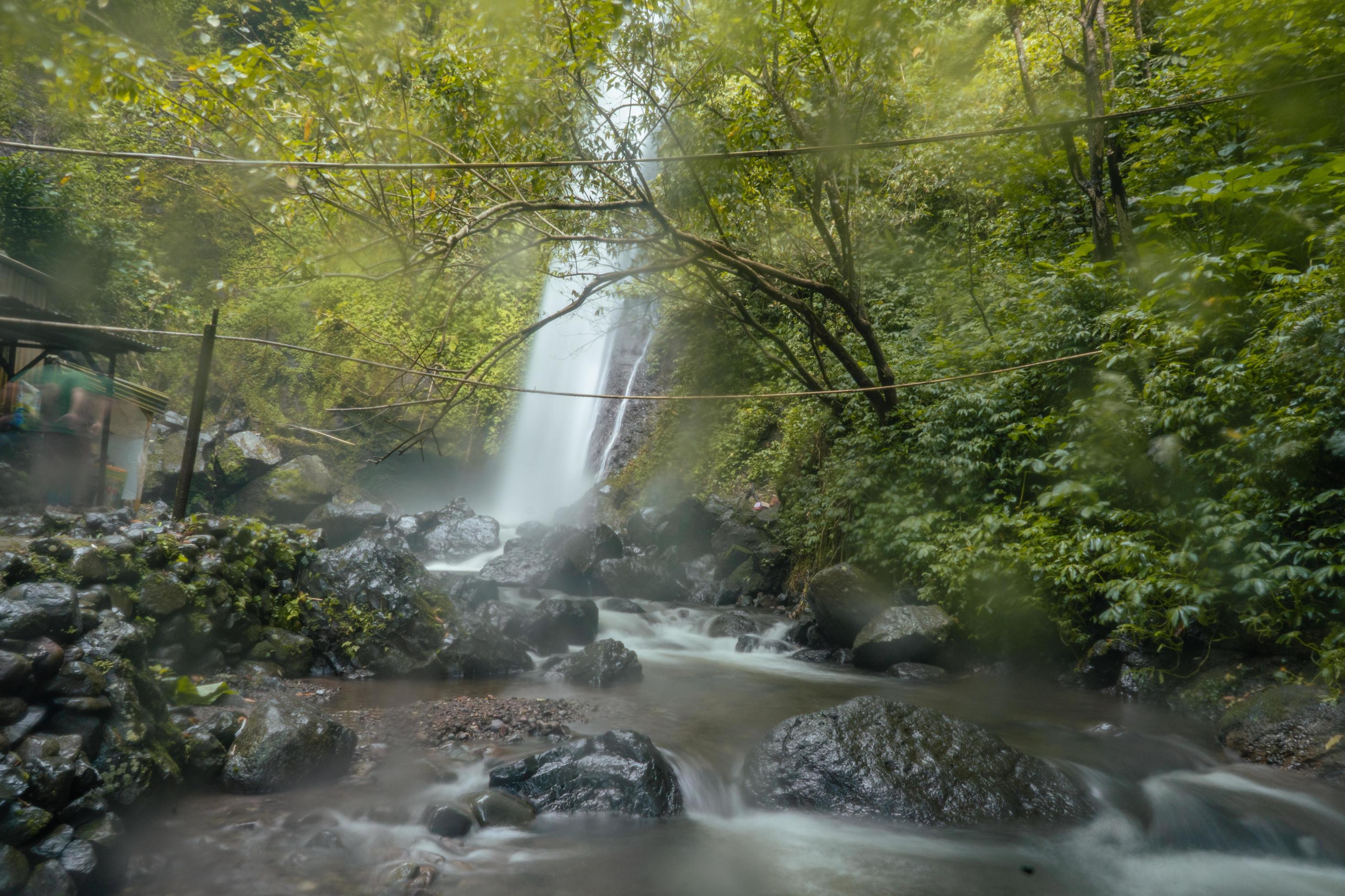 Water fall on tropical forest. Water flowing through river stone. The footage is suitable to use for nature footage, and travel destination footage. Stock Free