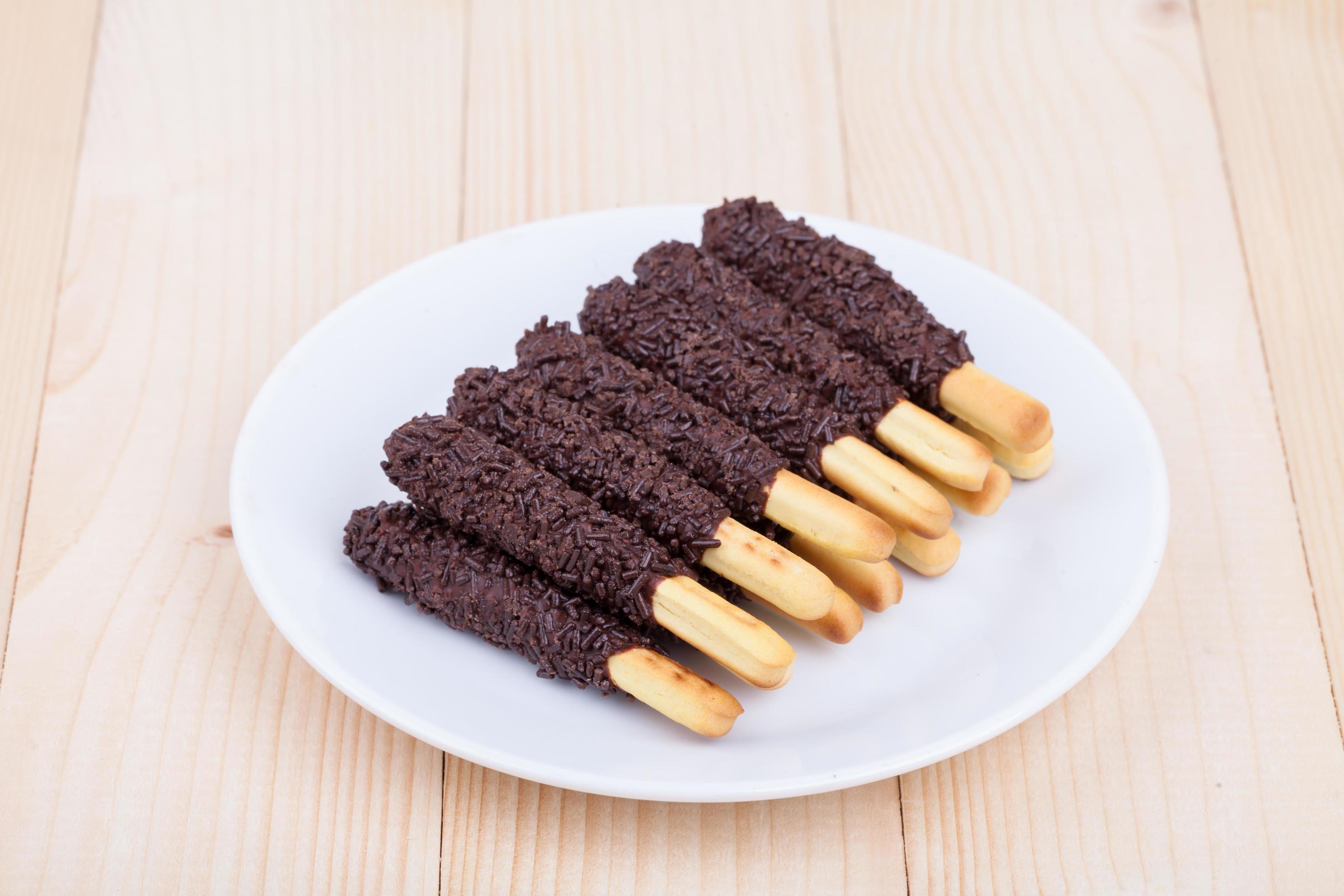 snack food biscuit stick chocolate coated on wood blackground Stock Free