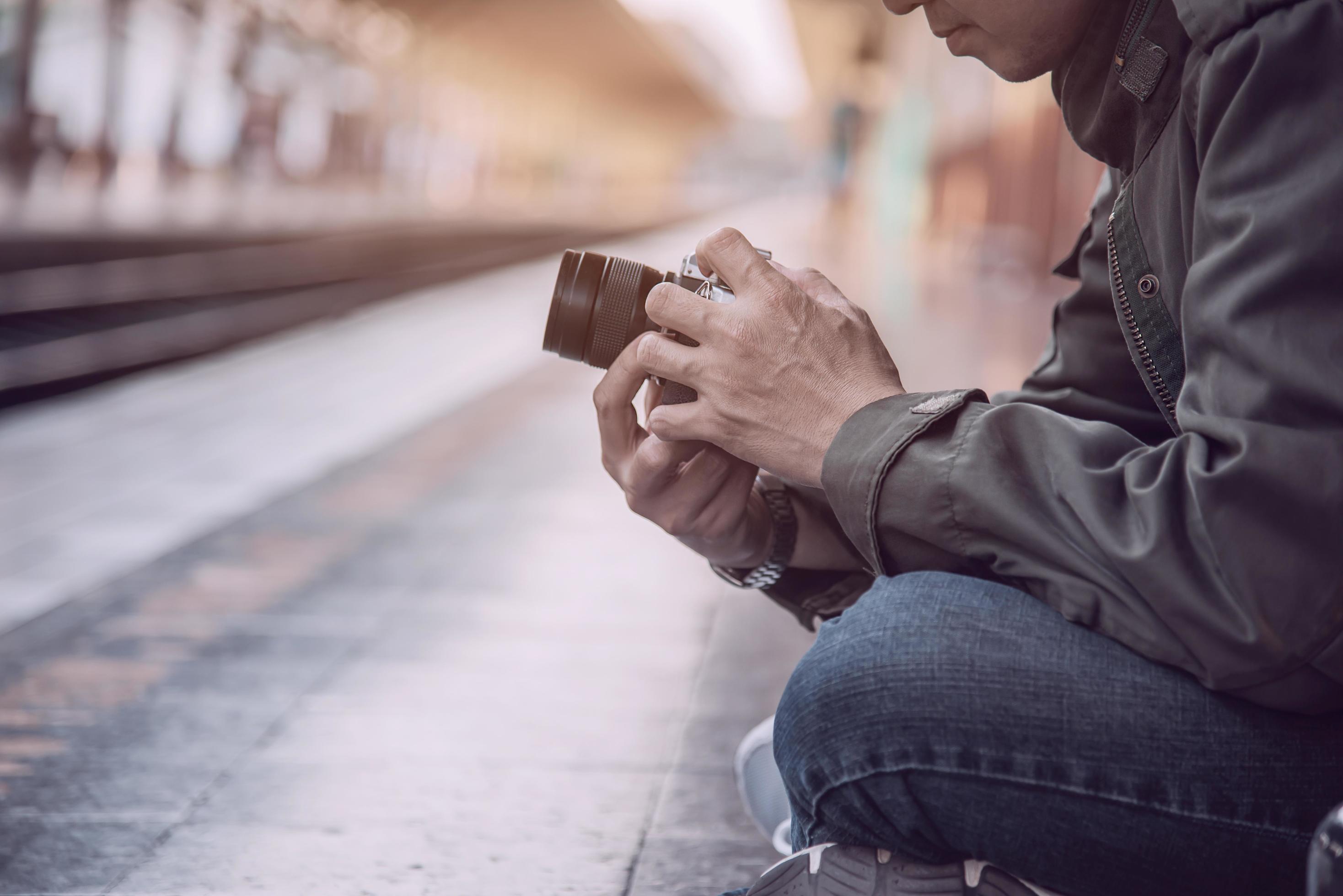 Travel man wait train at platform – people vacation lifestyle activities at train station transportation concept Stock Free