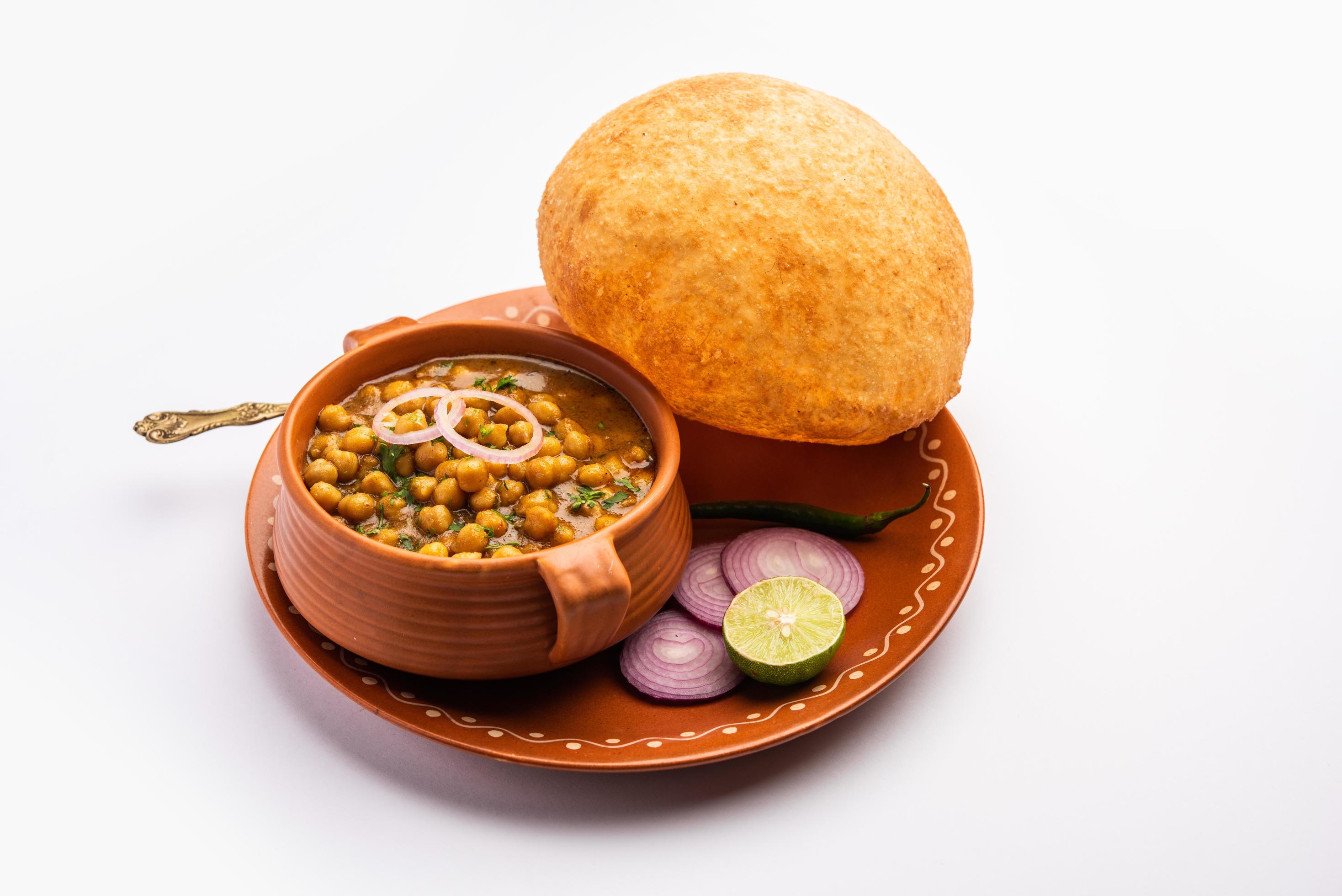 Chole bhature is a North Indian food dish. A combination of chana masala and bhatura or puri Stock Free