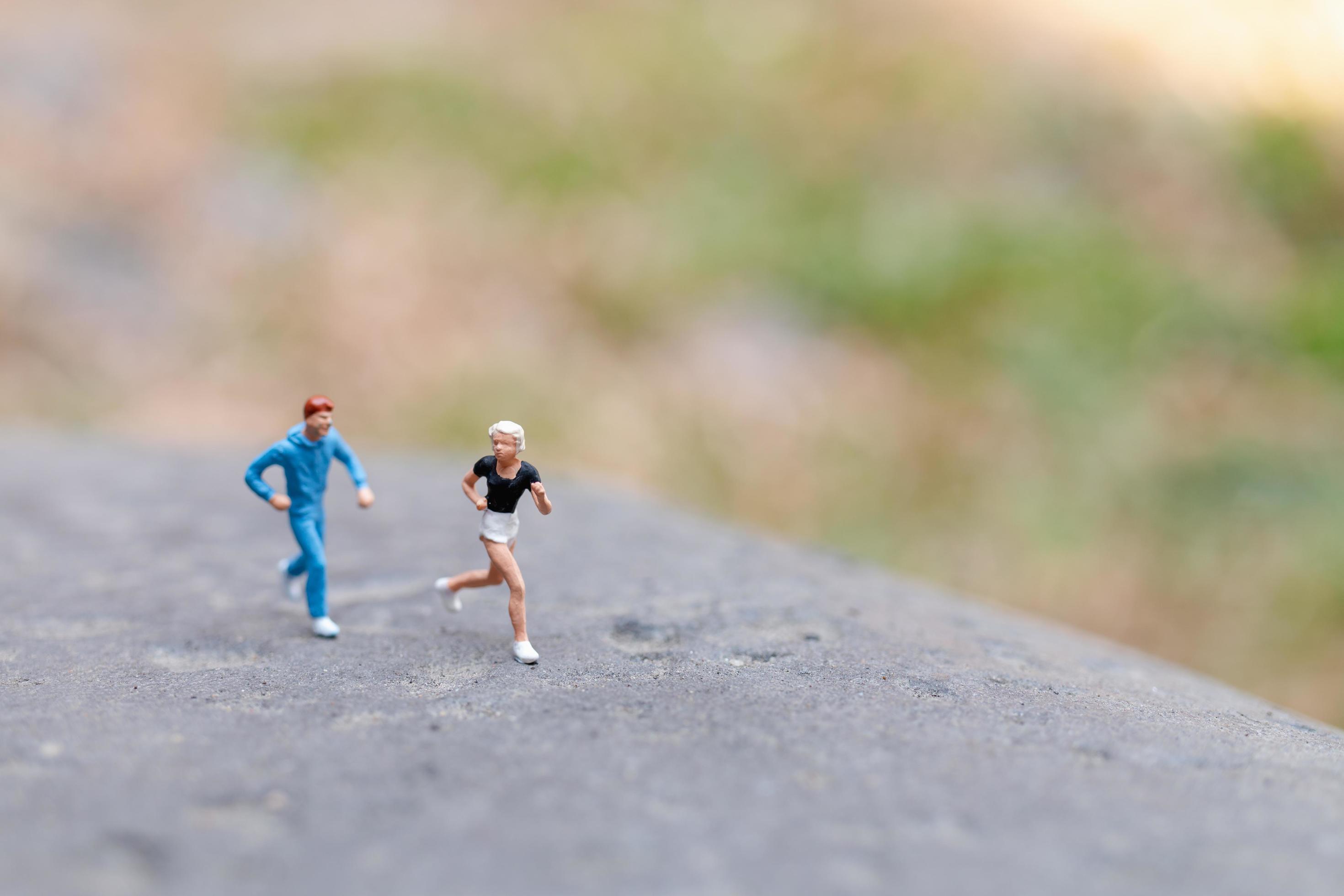 Miniature people running on a rock, health and lifestyle concept Stock Free