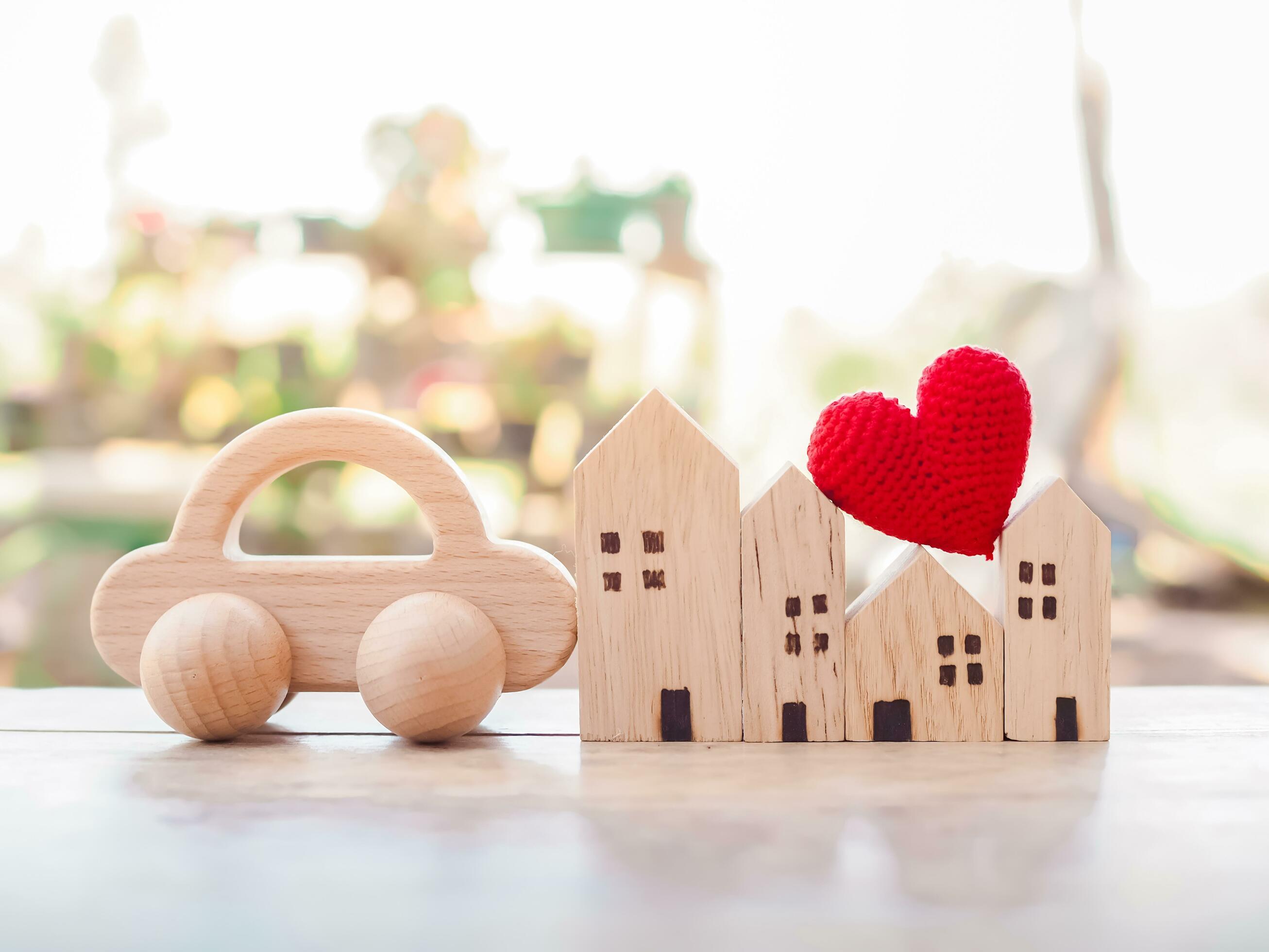 Miniature house, Red heart and wooden toy car. Concept of family Stock Free