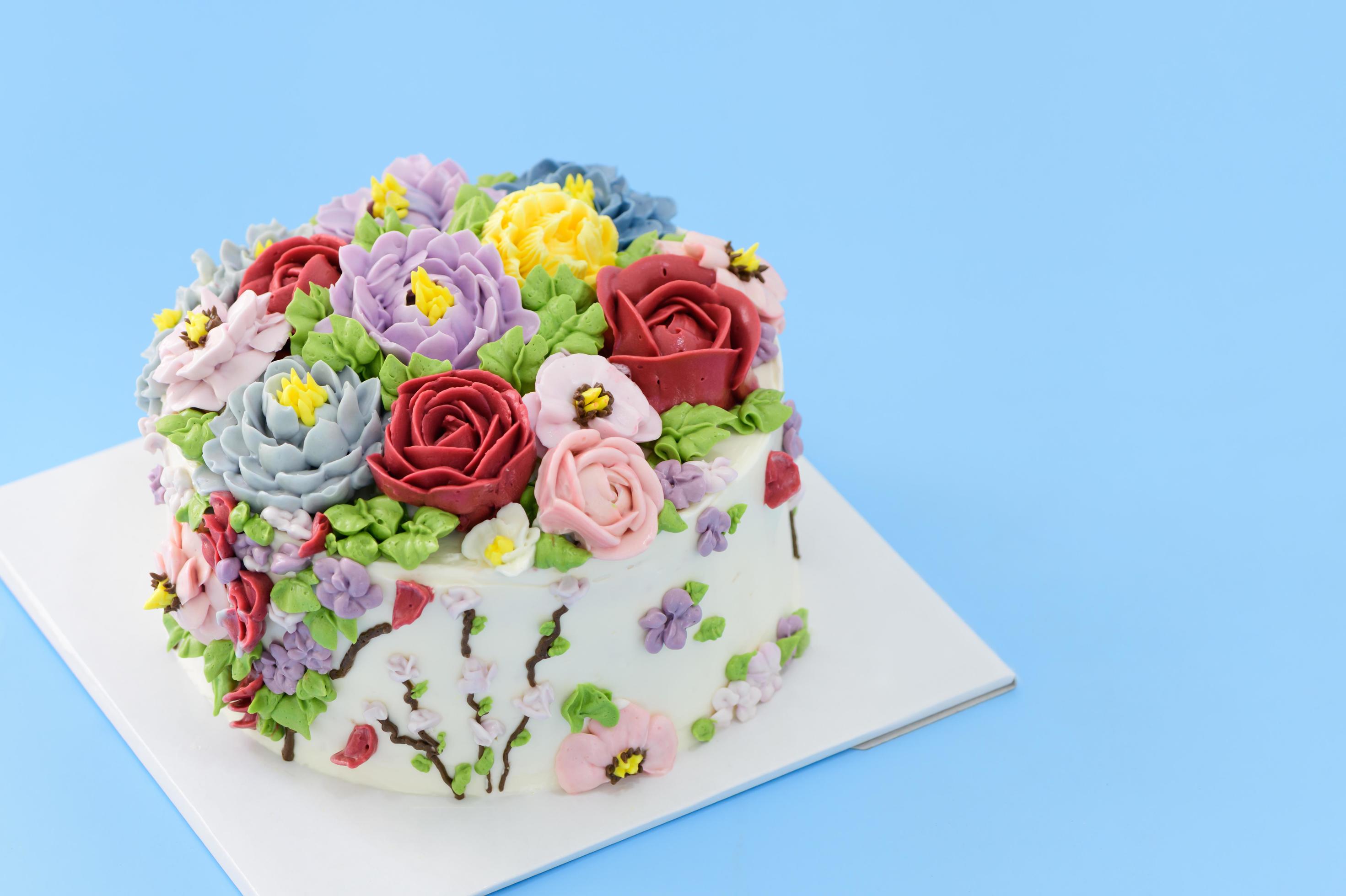 Homemade cake decorated with beautiful flowers on blue background, Stock Free