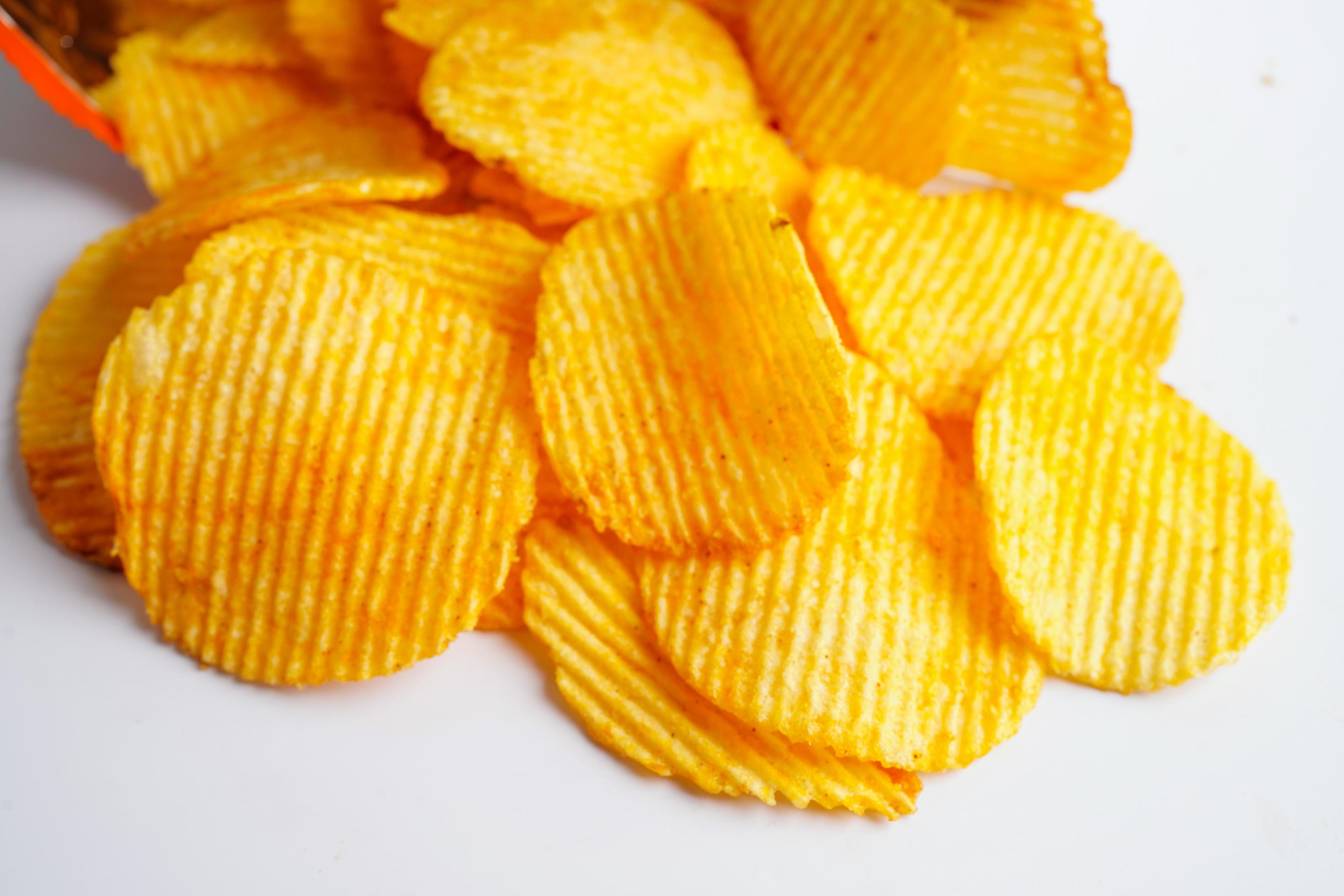 Potato chips in open bag, delicious BBQ seasoning spicy for crips, thin slice deep fried snack fast food. Stock Free