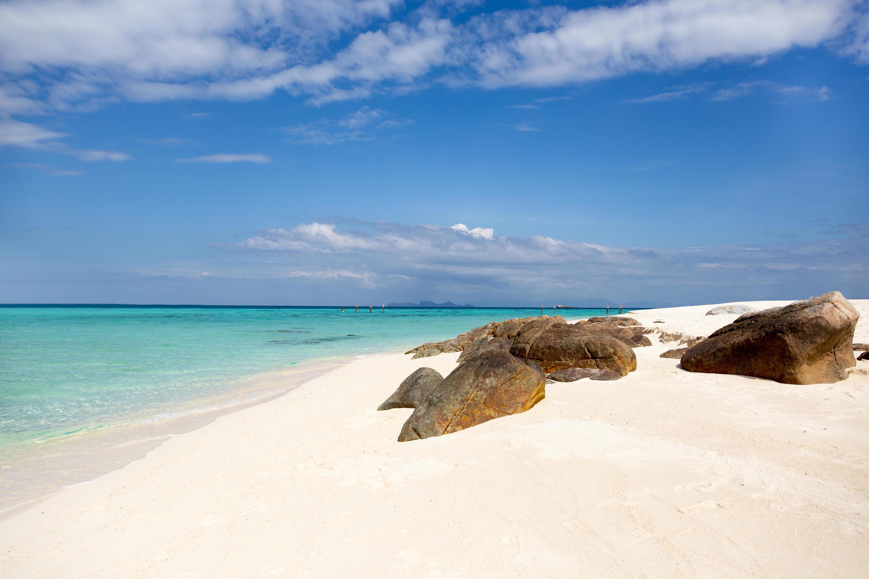 Beautiful ocean with white sandy beach and blue sky in tropical island. Stock Free