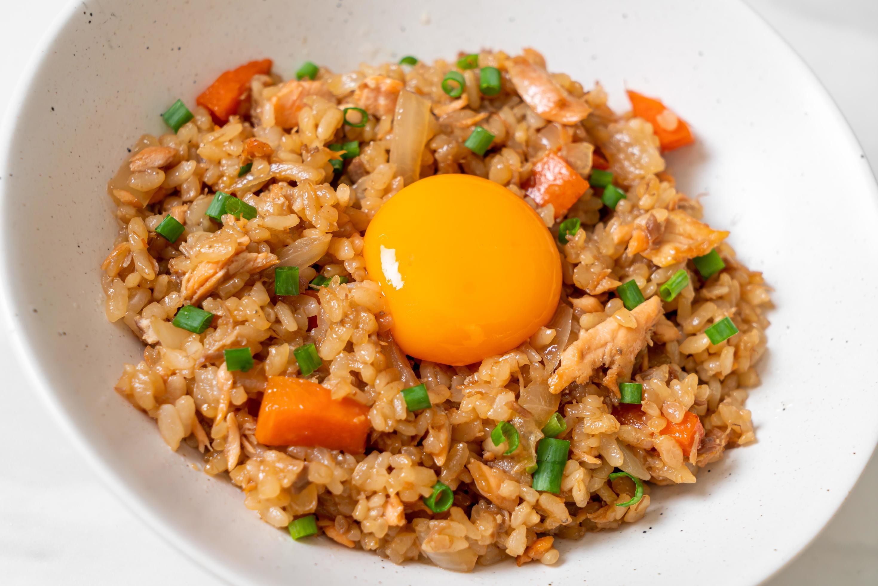 Salmon fried rice with pickled egg on top – Asian food style Stock Free