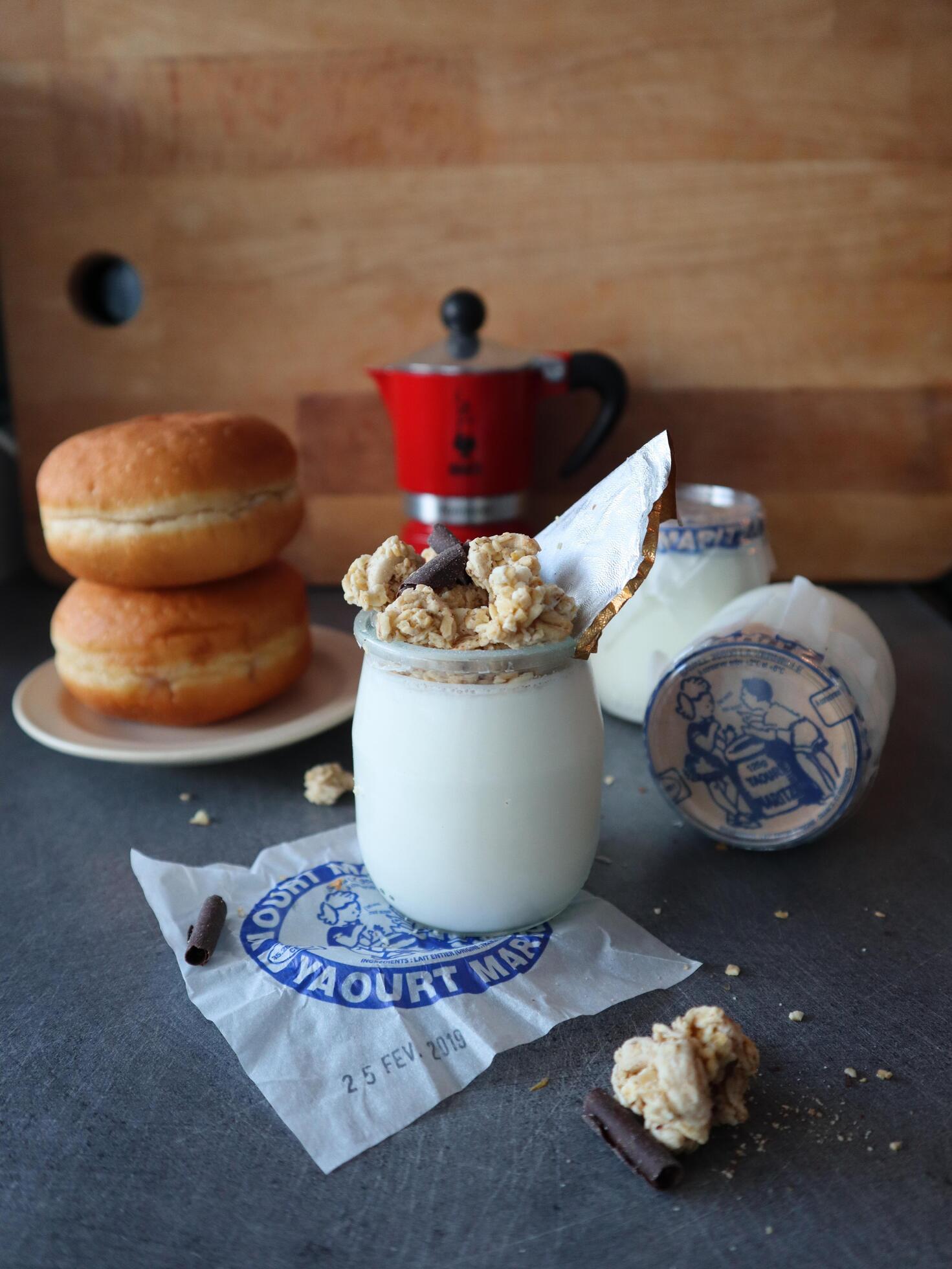 Glass jar with homemade yoghurt and granola breakfast Stock Free