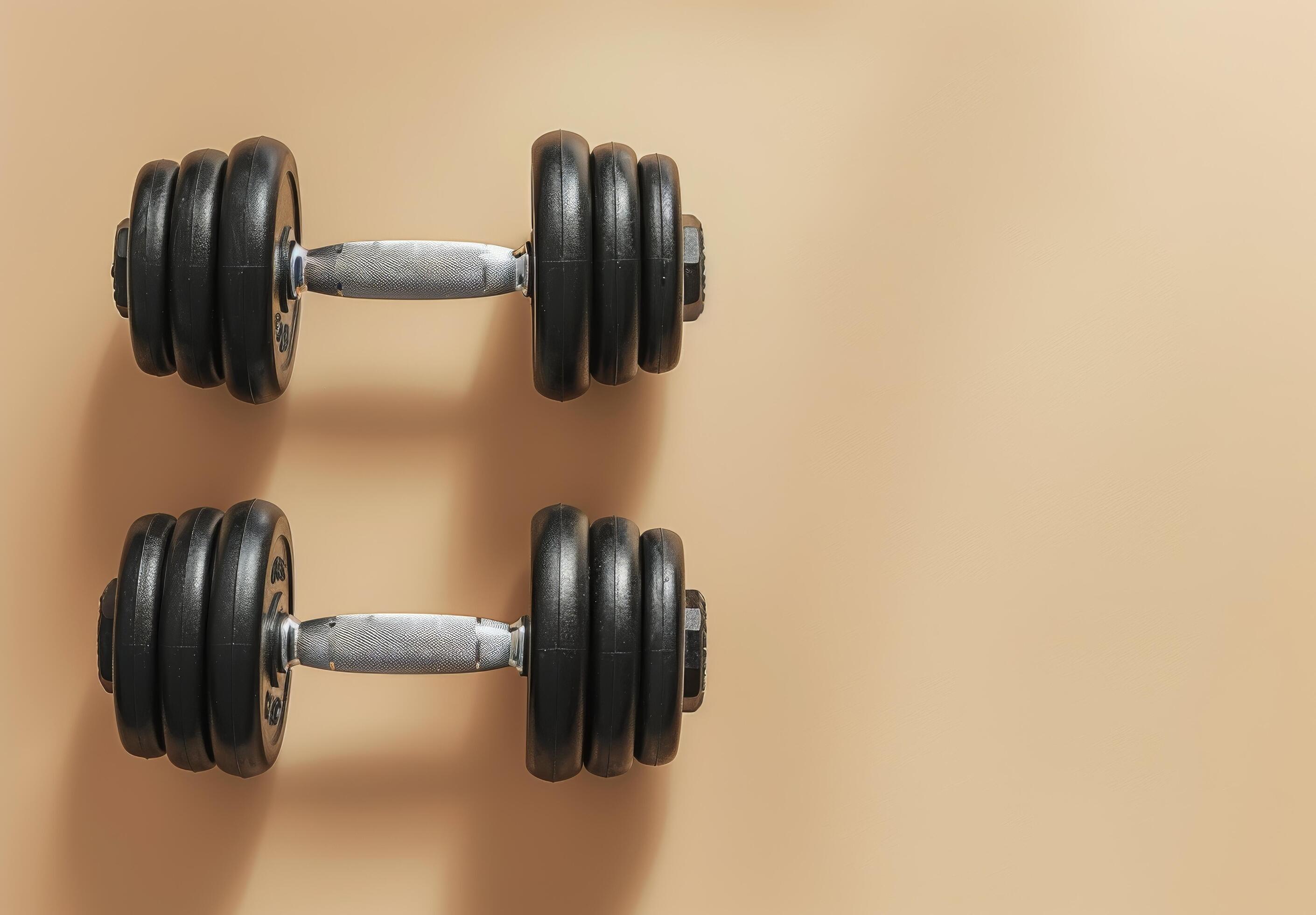 Single Black Dumbbell On A Beige Background Stock Free