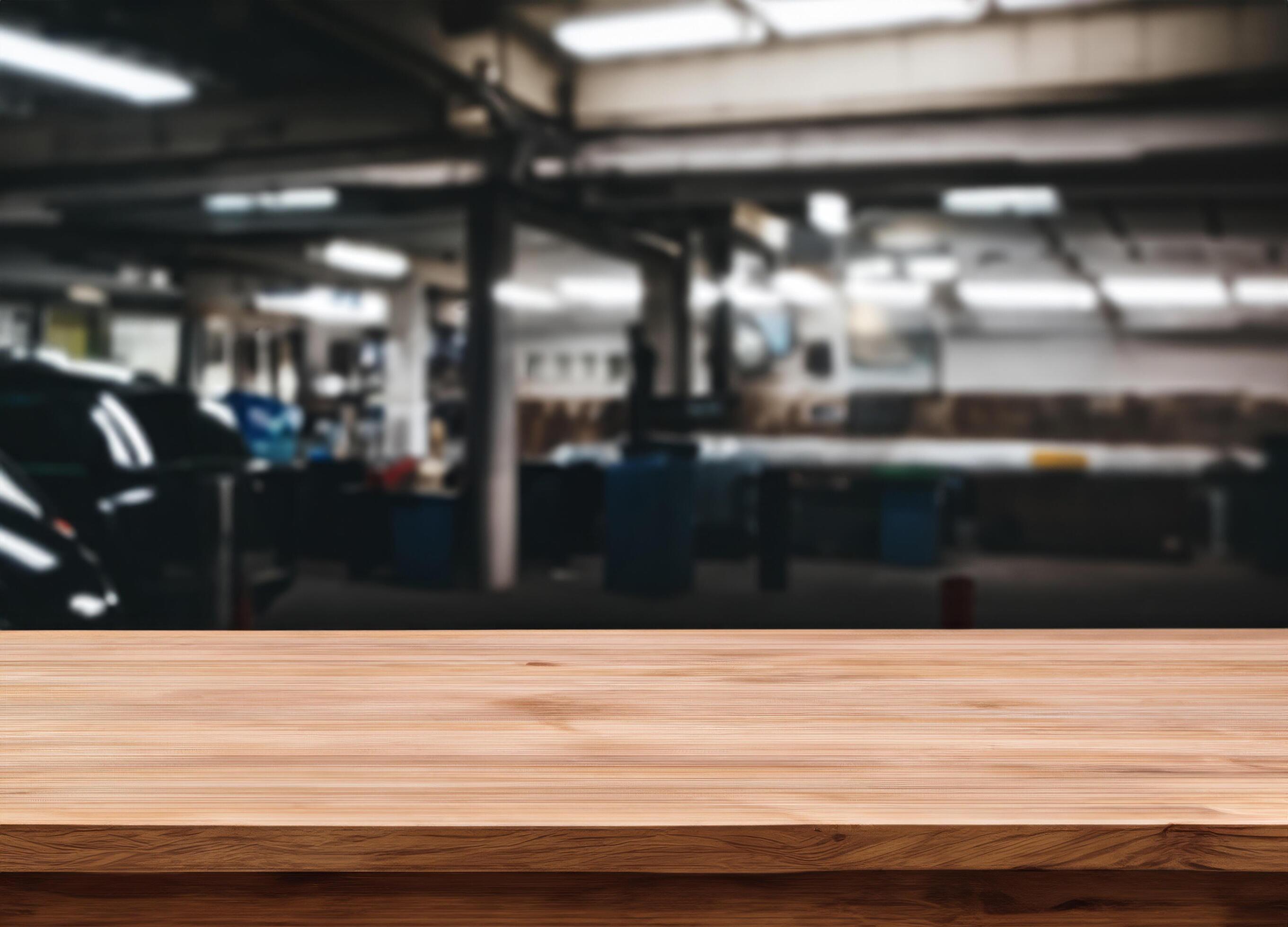 Wood table for product display in front of blurred factory garage Stock Free