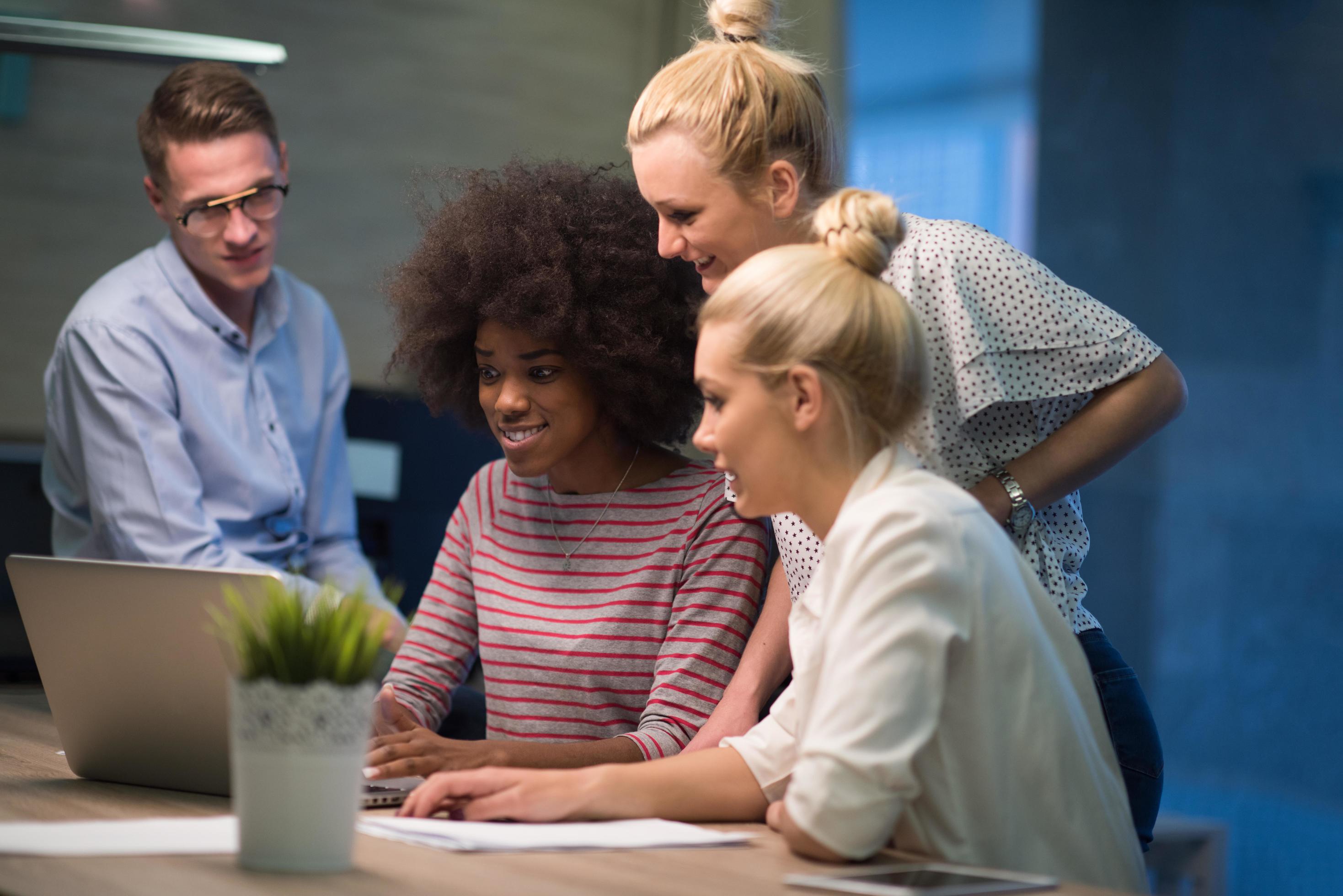 Multiethnic startup business team in night office Stock Free