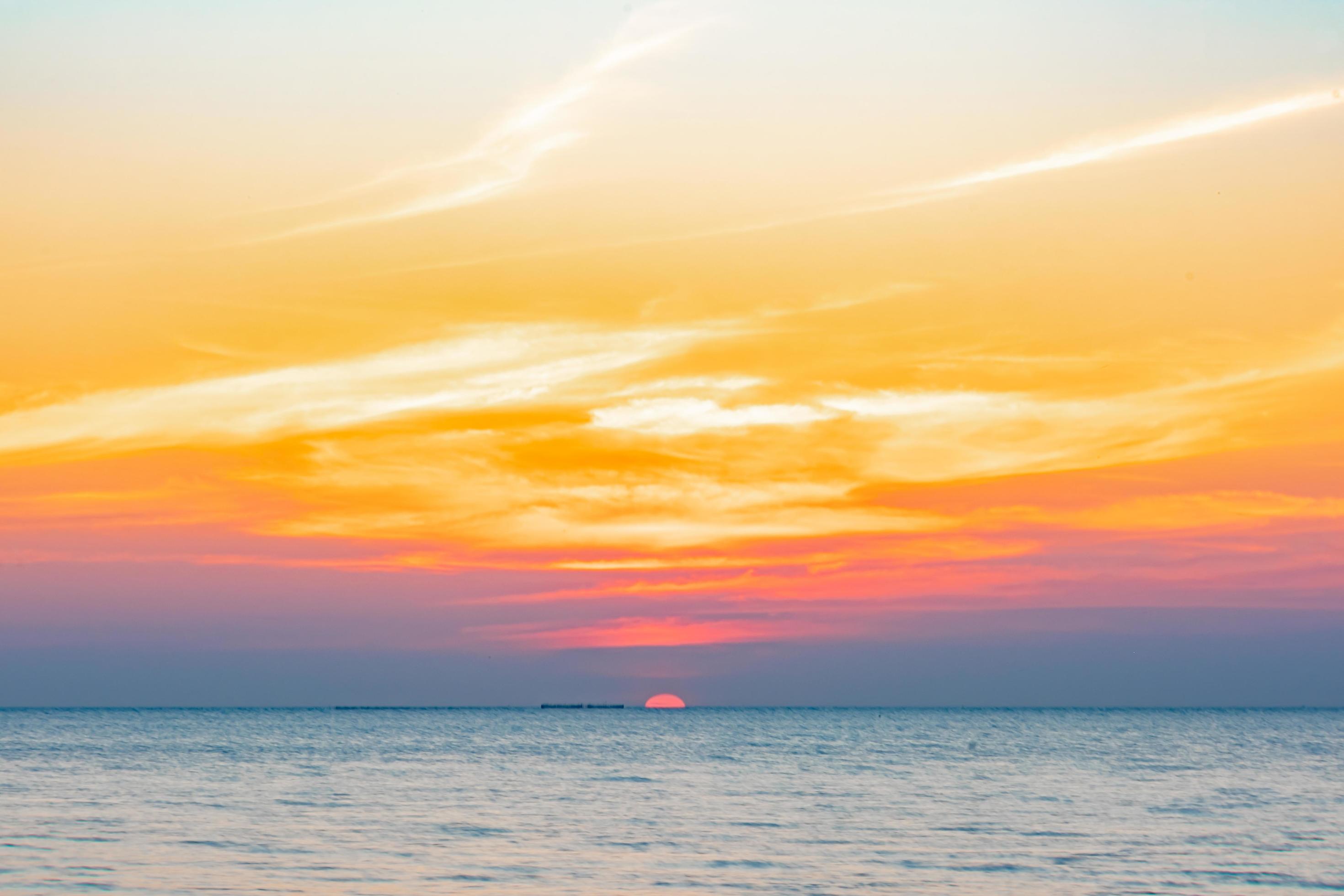 Tropical Colorful sunset over ocean on the beach. at Thailand Tourism background with sea beach. Holiday journey destination Stock Free