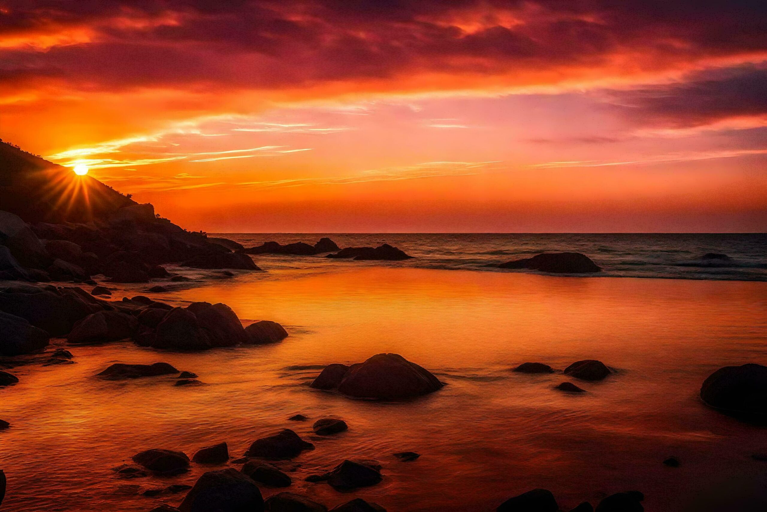 the sun sets over the ocean and rocks Free Photo