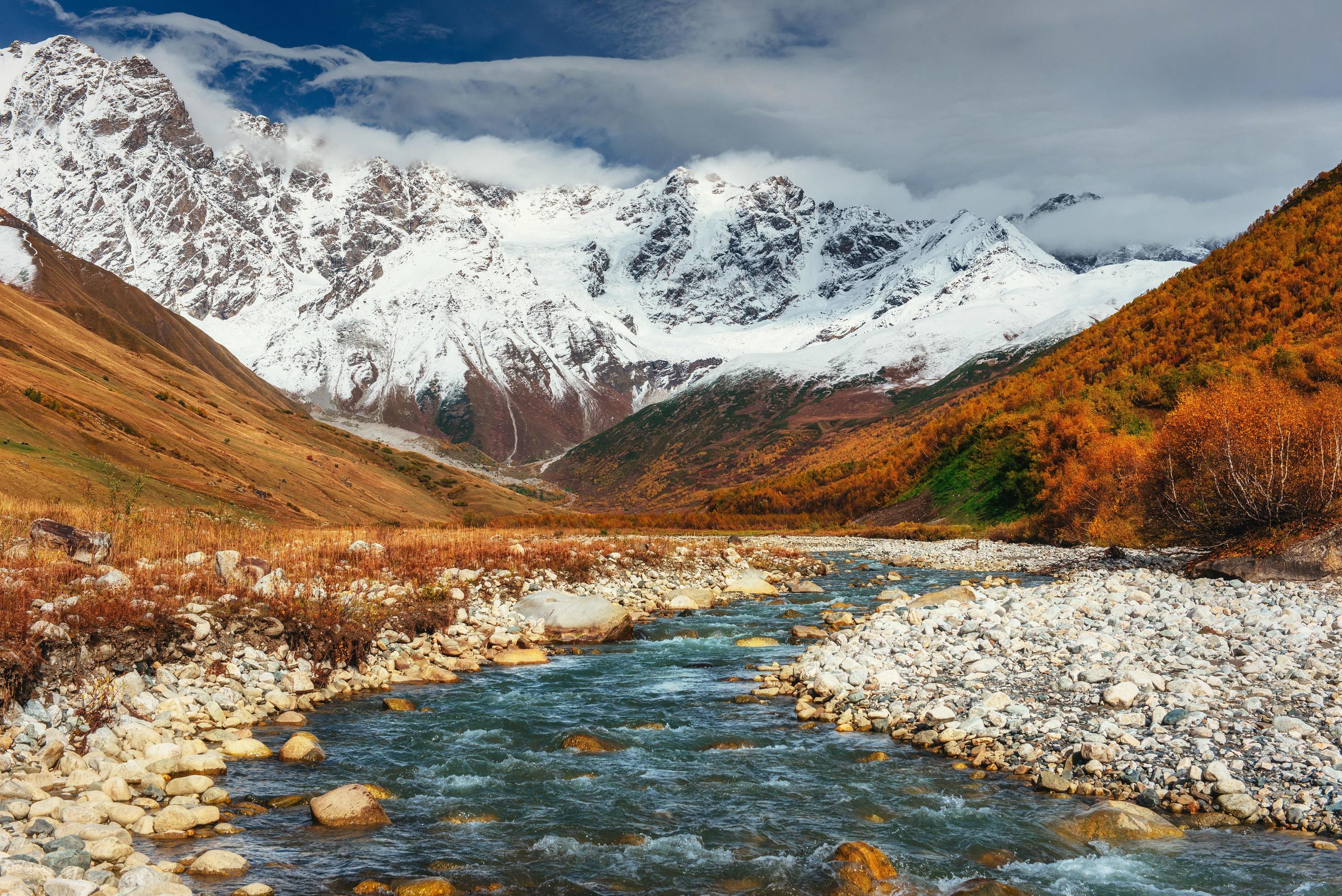 Snowy mountains and noisy mountain river. Georgia, Svaneti. Euro Stock Free