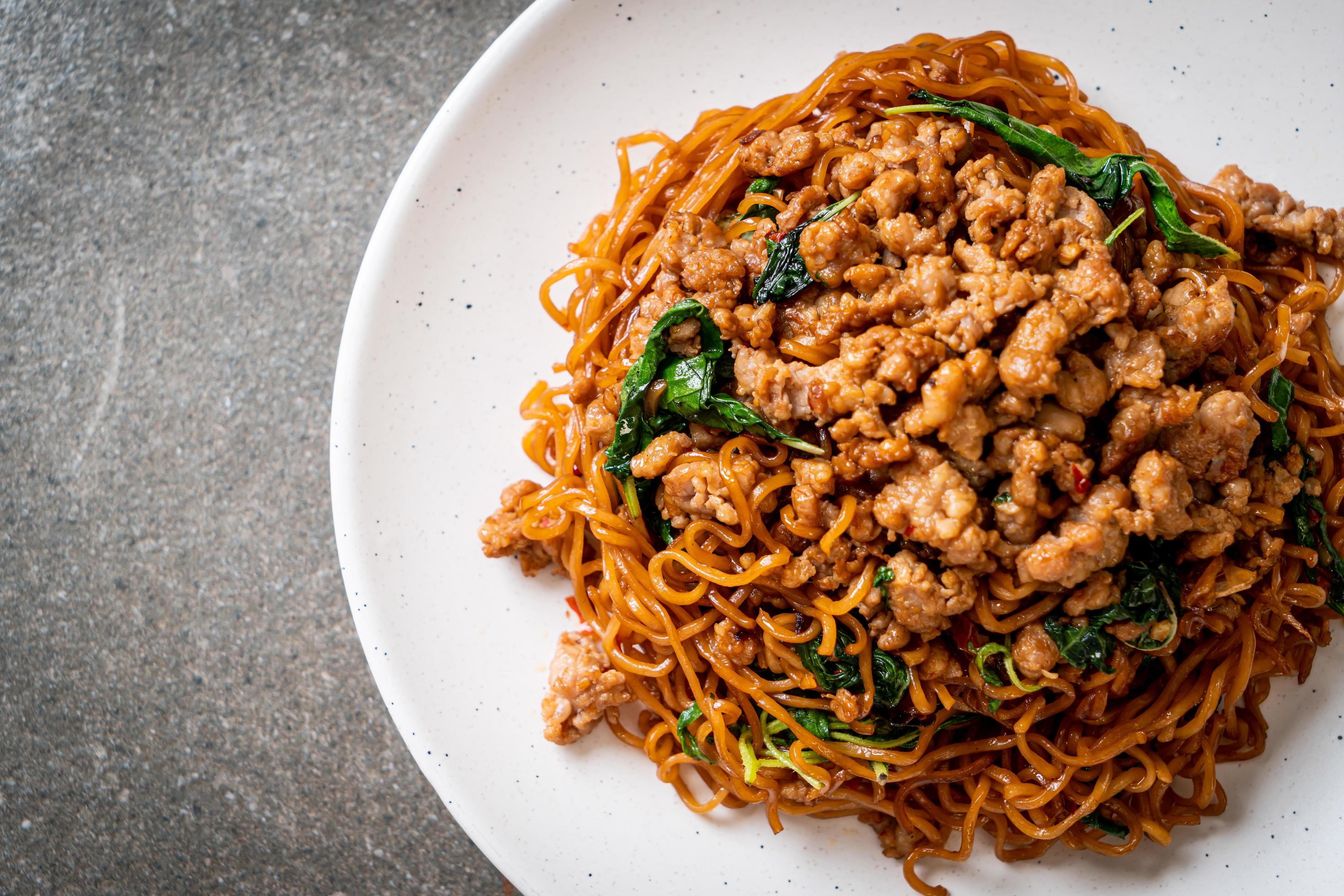 Stir-fried instant noodles with Thai basil and minced pork – Asian food style Stock Free