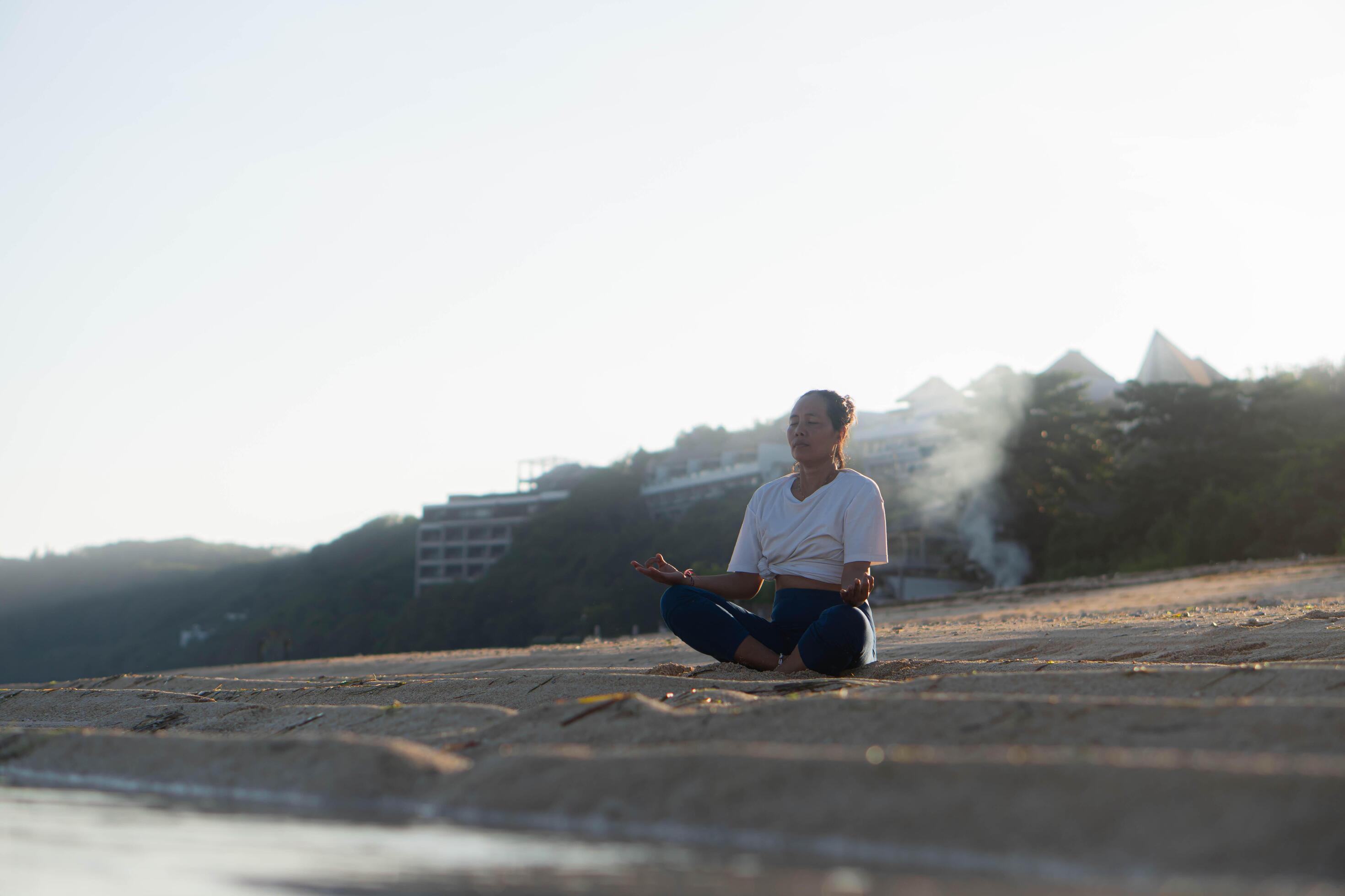 healthy woman with beautiful body doing yoga at sunrise on the beach, yoga poses Stock Free