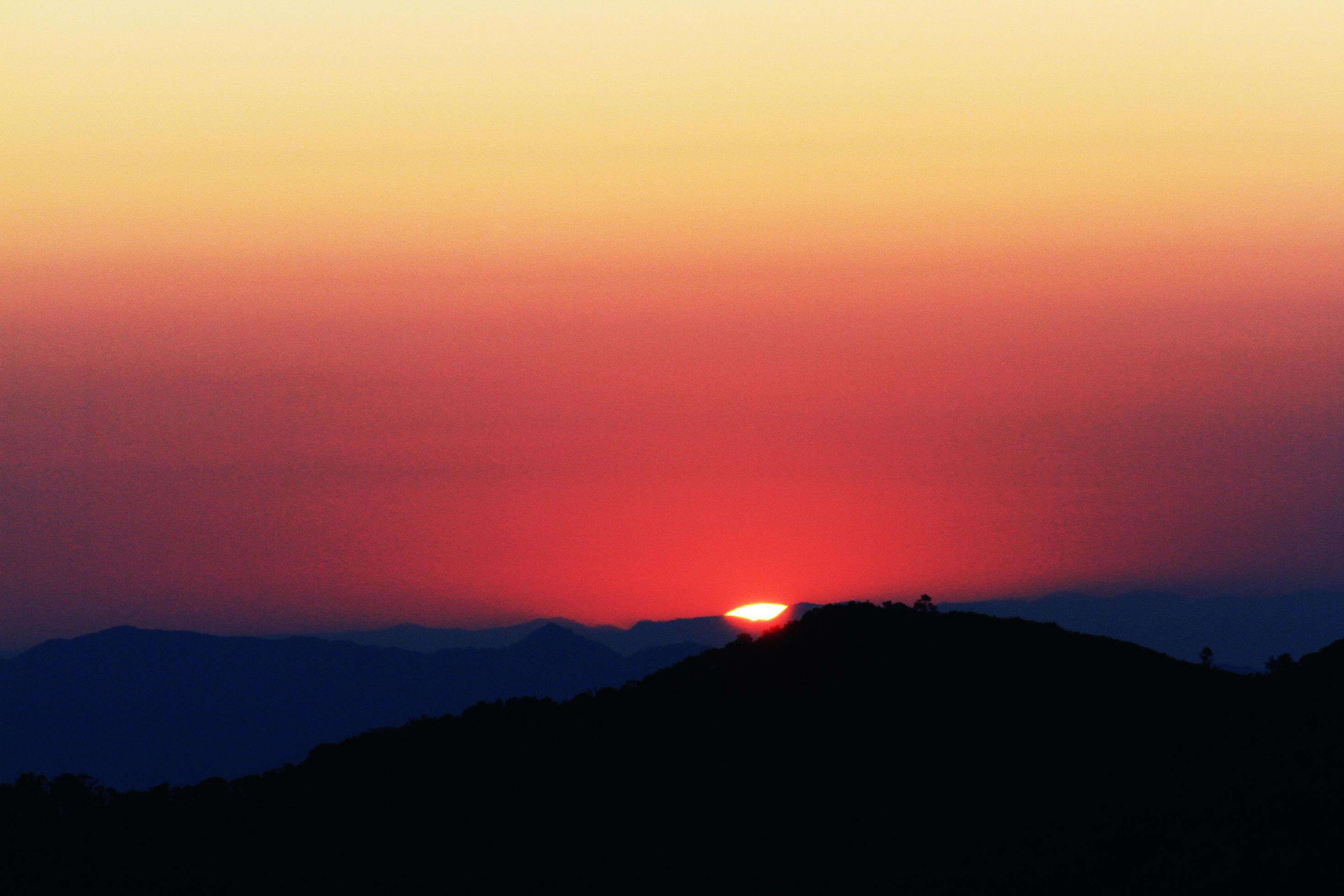 Sunset in sky and cloud, beautiful colorful twilight time with silhouette of mountain. Stock Free