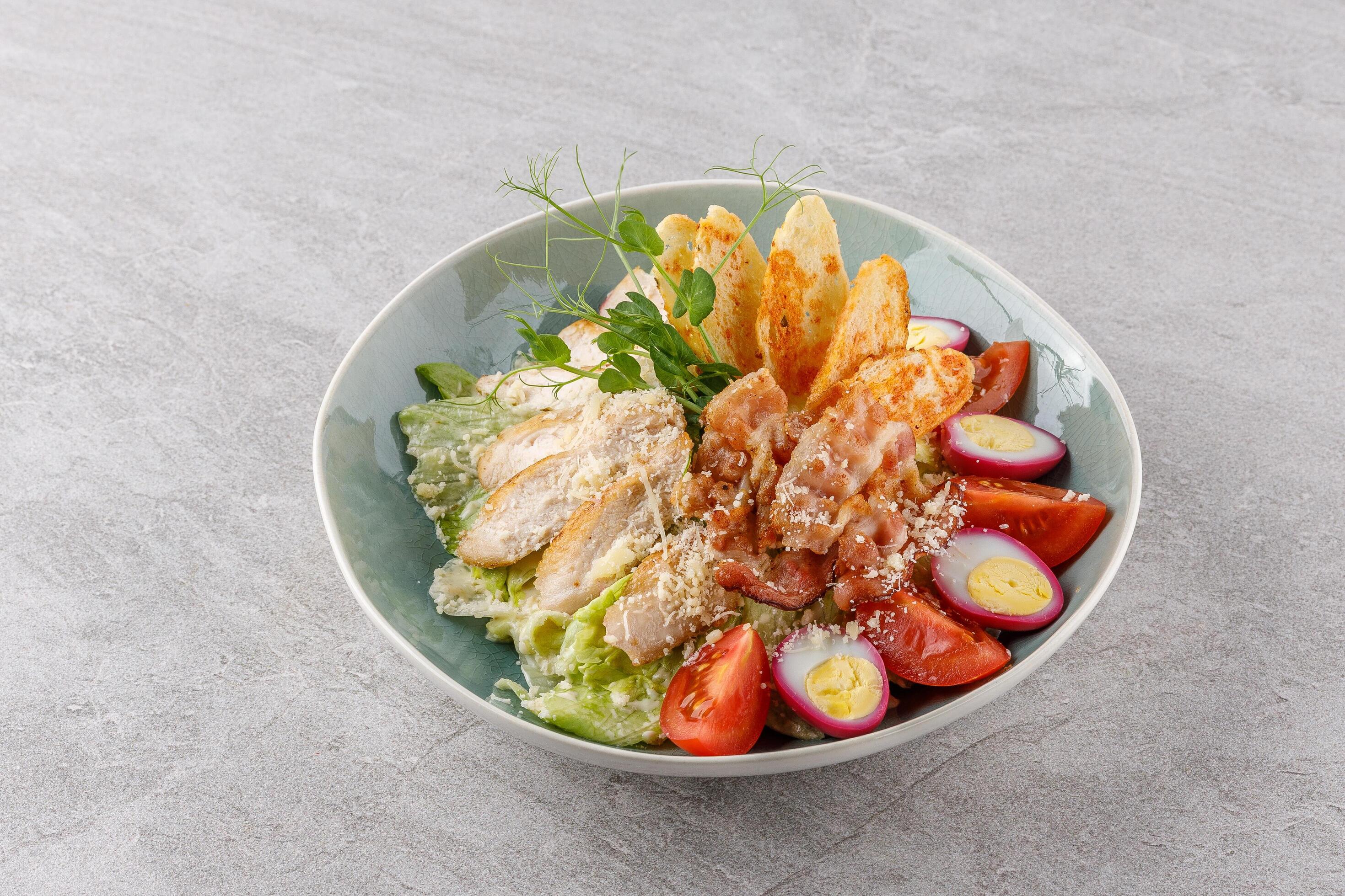 
									Caesar salad with chicken and bacon on a stone background studio food photo 5 Stock Free