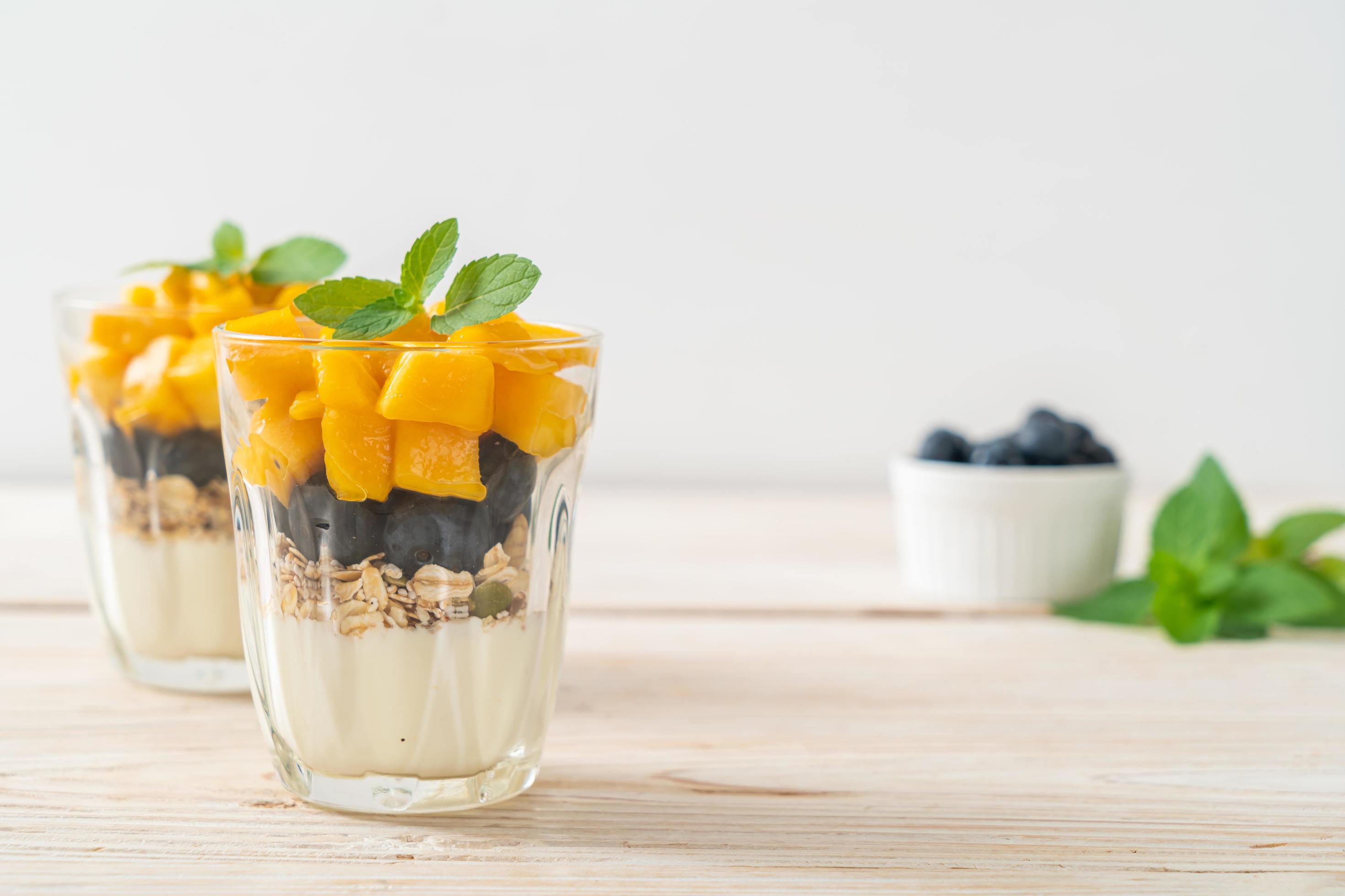 Homemade fresh mango and fresh blueberry with yogurt and granola – healthy food style Stock Free