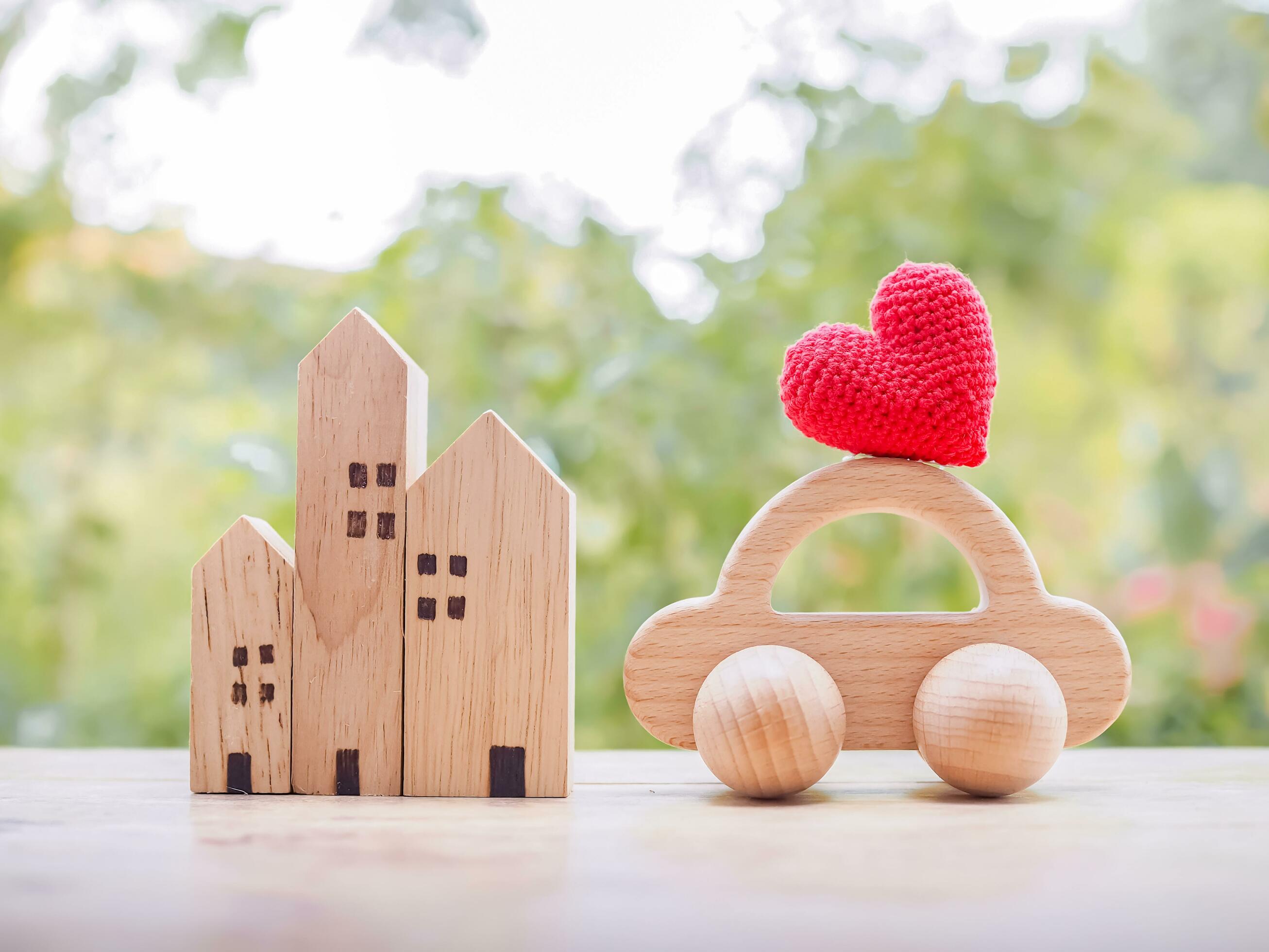 Miniature house, Red heart and wooden toy car. Concept of family Stock Free