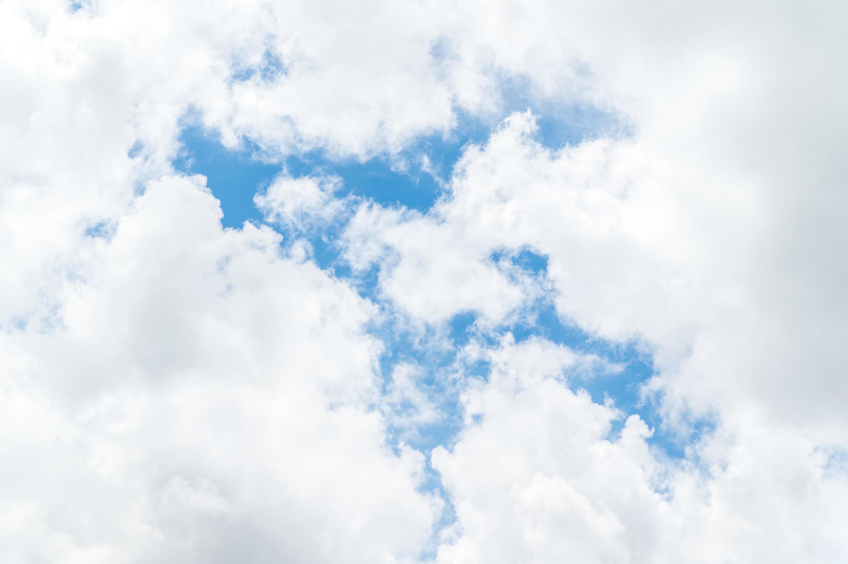 Beautiful white fluffy clouds in blue sky. Nature background from white clouds in sunny day Stock Free