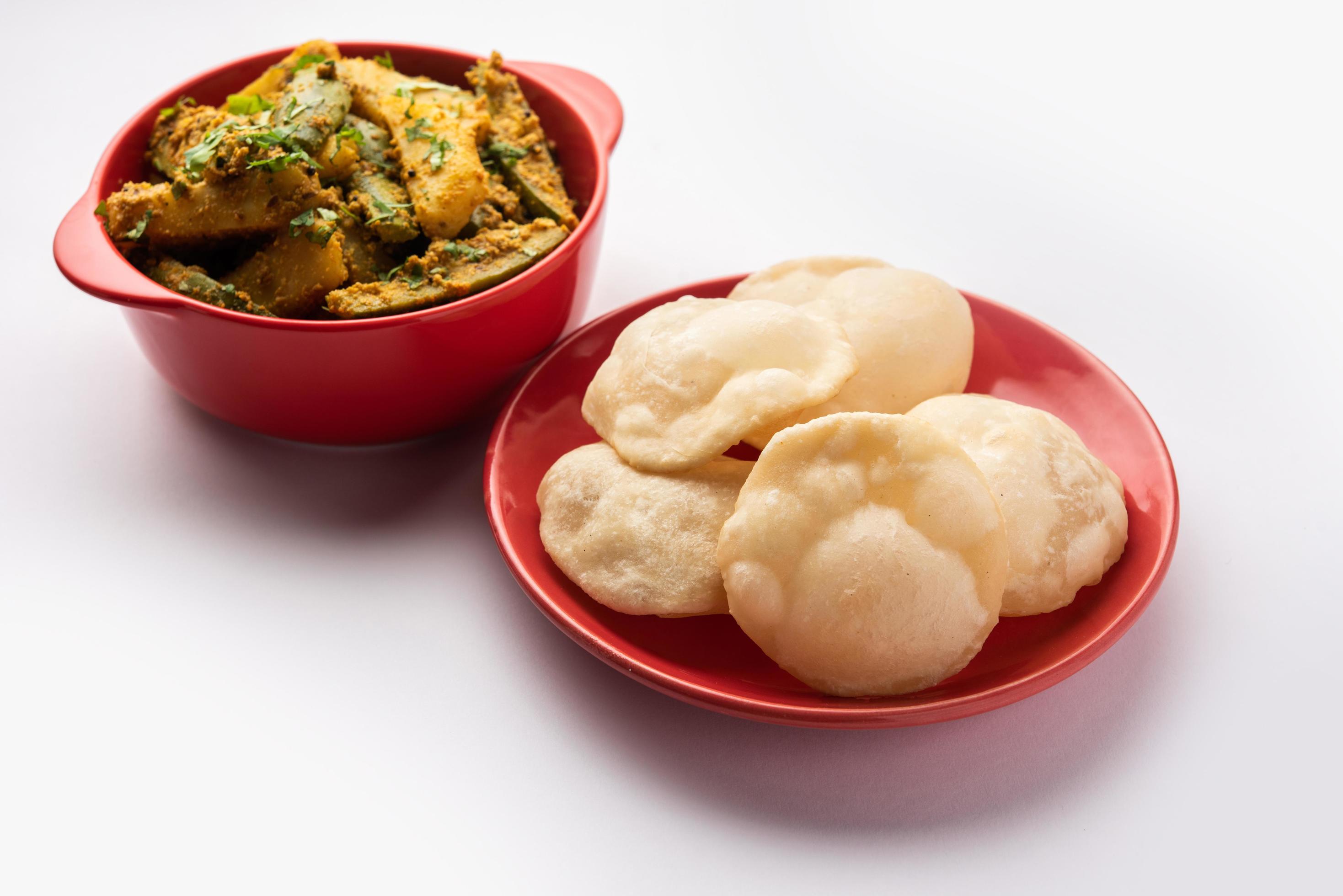 Aloo Patol sabzi made using pointed gourd and potato served with fried Luchi or poori, Bengali food Stock Free