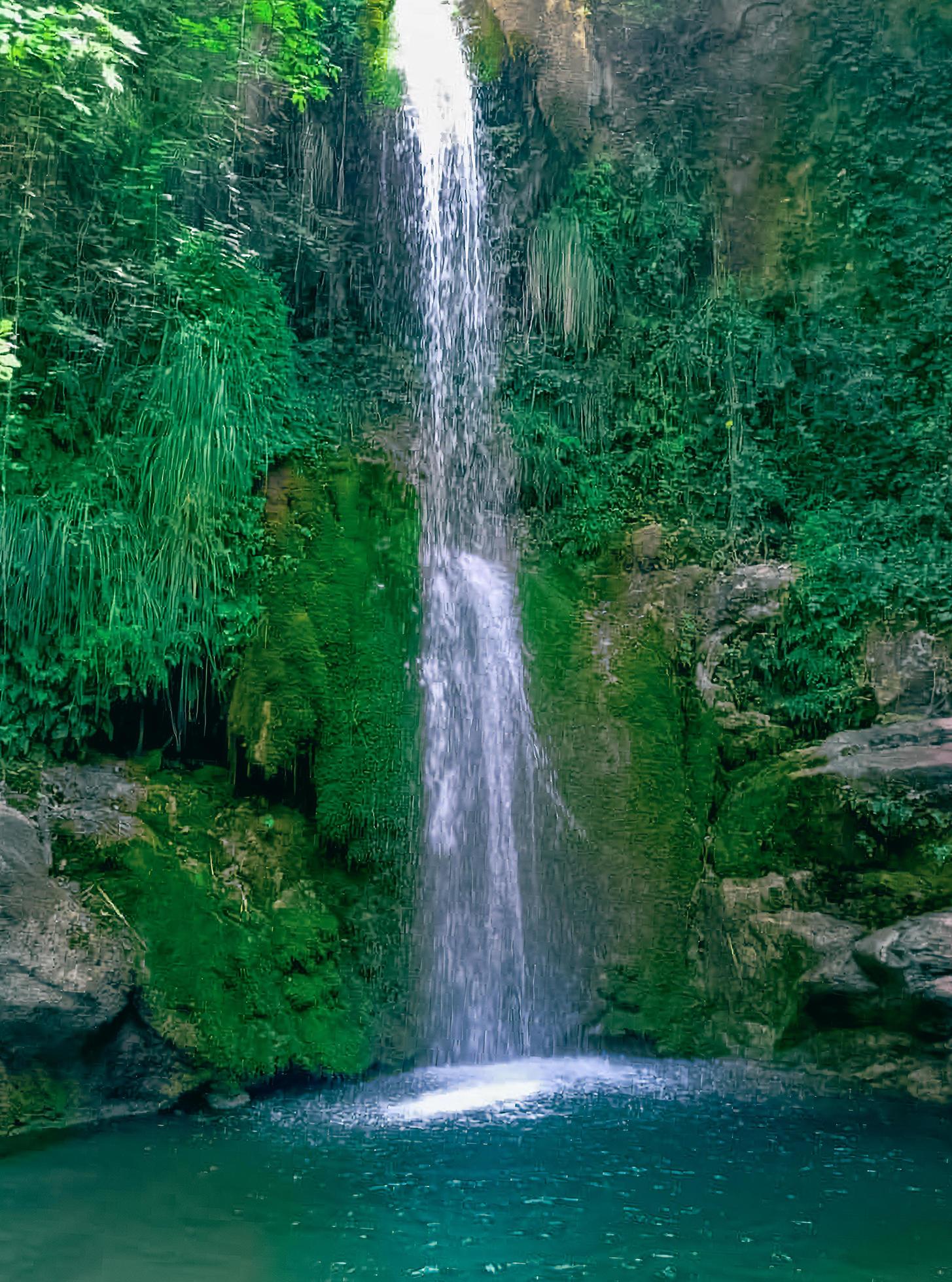 Mesmerizing beauty of a waterfall in a verdant valley – a journey into the heart of nature magnificent and serene landscapes Stock Free