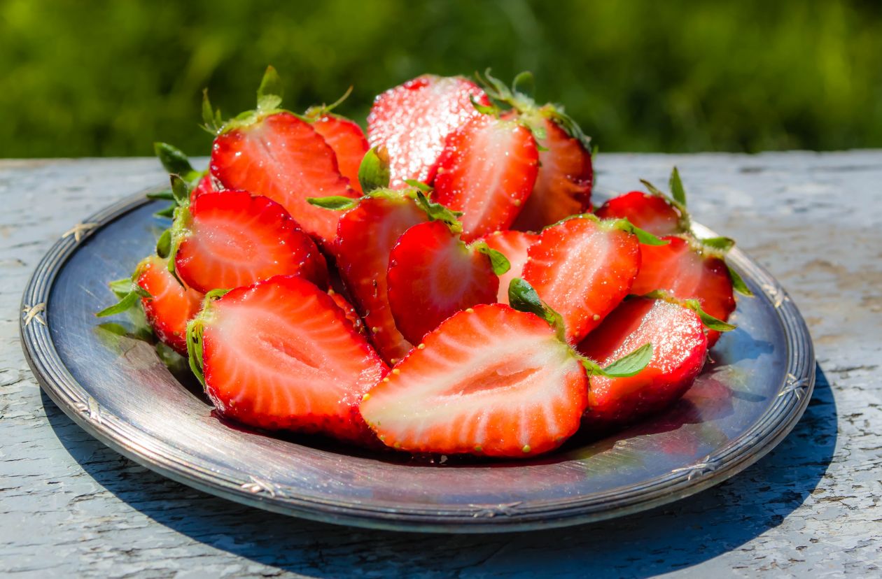 Strawberry plate outdoors Stock Free