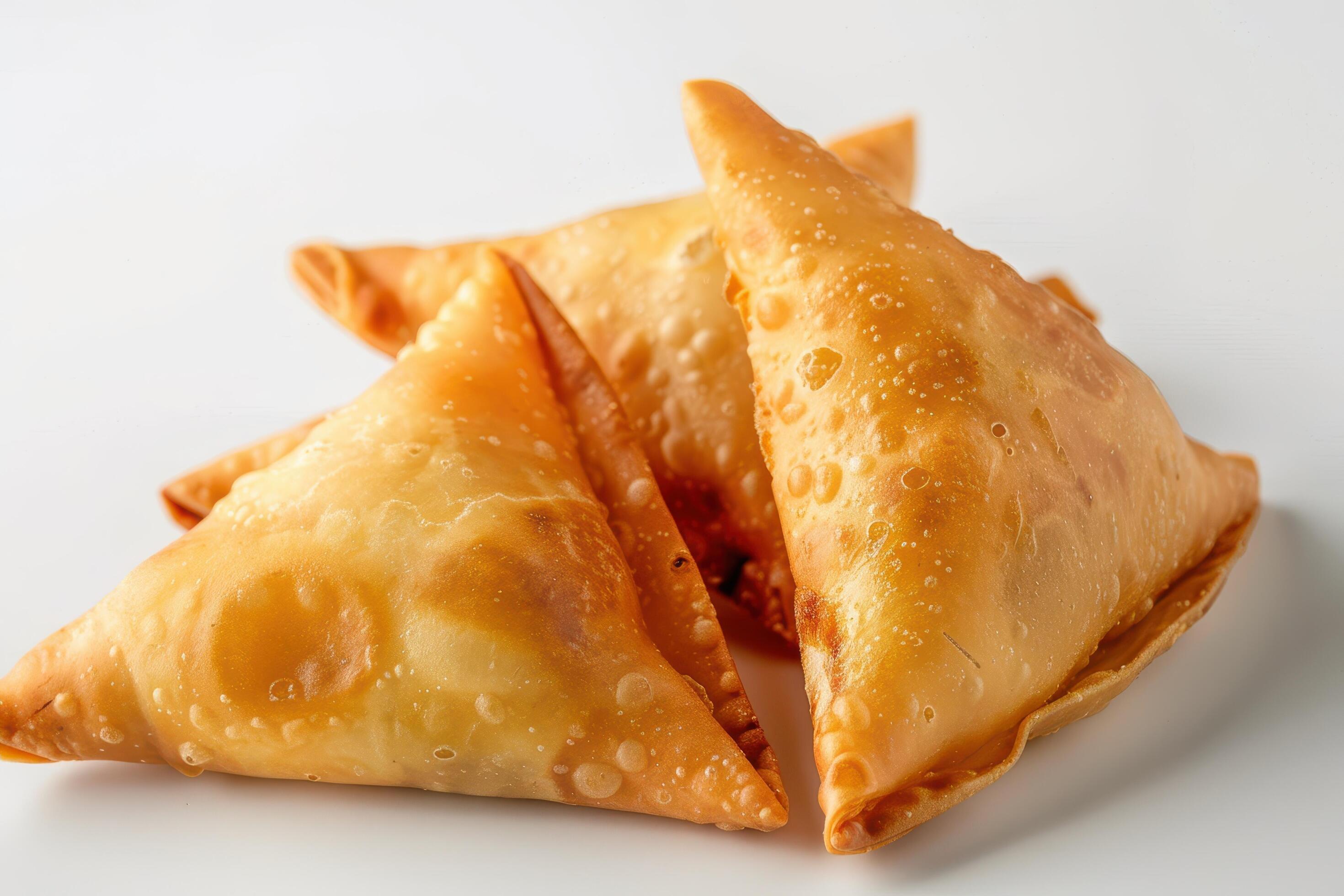 Three Golden Fried Samosas on White Background Stock Free