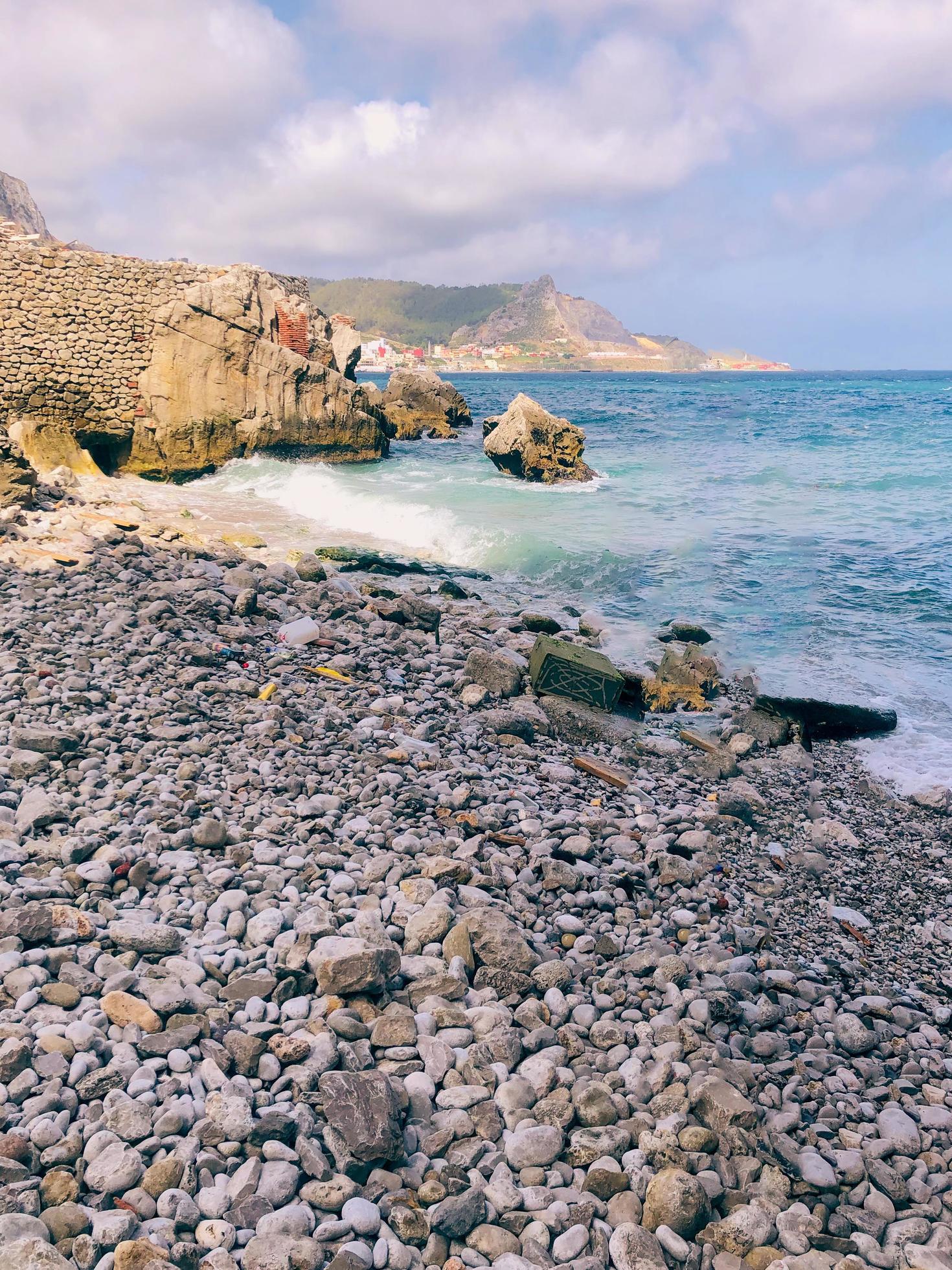 Uncover the treasures of nature and tranquility hidden gems of a stone-lined beach Stock Free