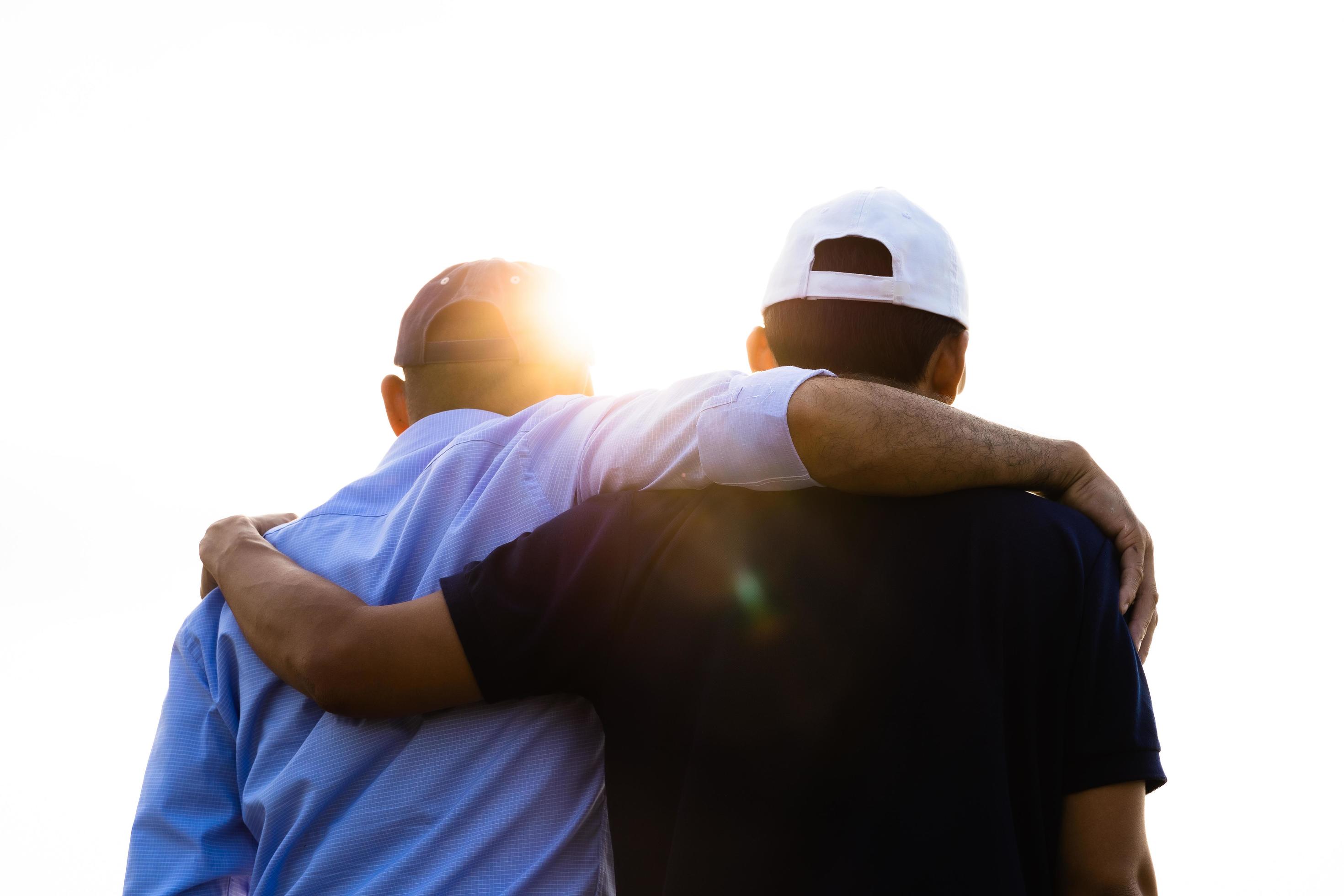 Closeup of male and female friends hugging each other looking at the sunrise. Happiness, success, friendship and community concepts. Stock Free