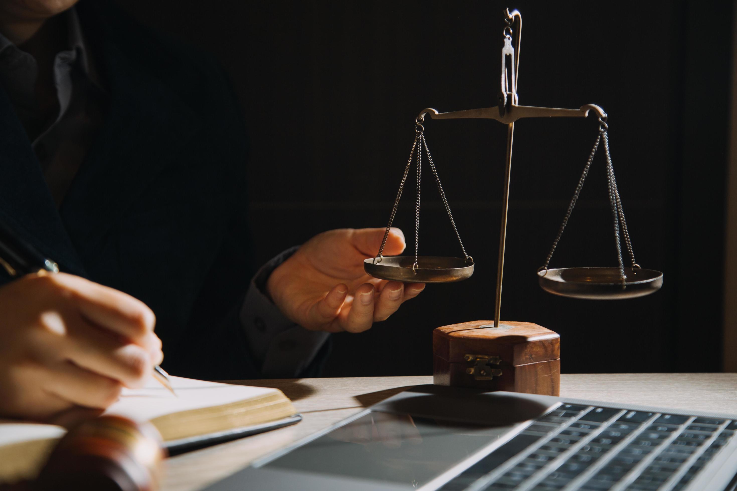 Business and lawyers discussing contract papers with brass scale on desk in office. Law, legal services, advice, justice and law concept Stock Free