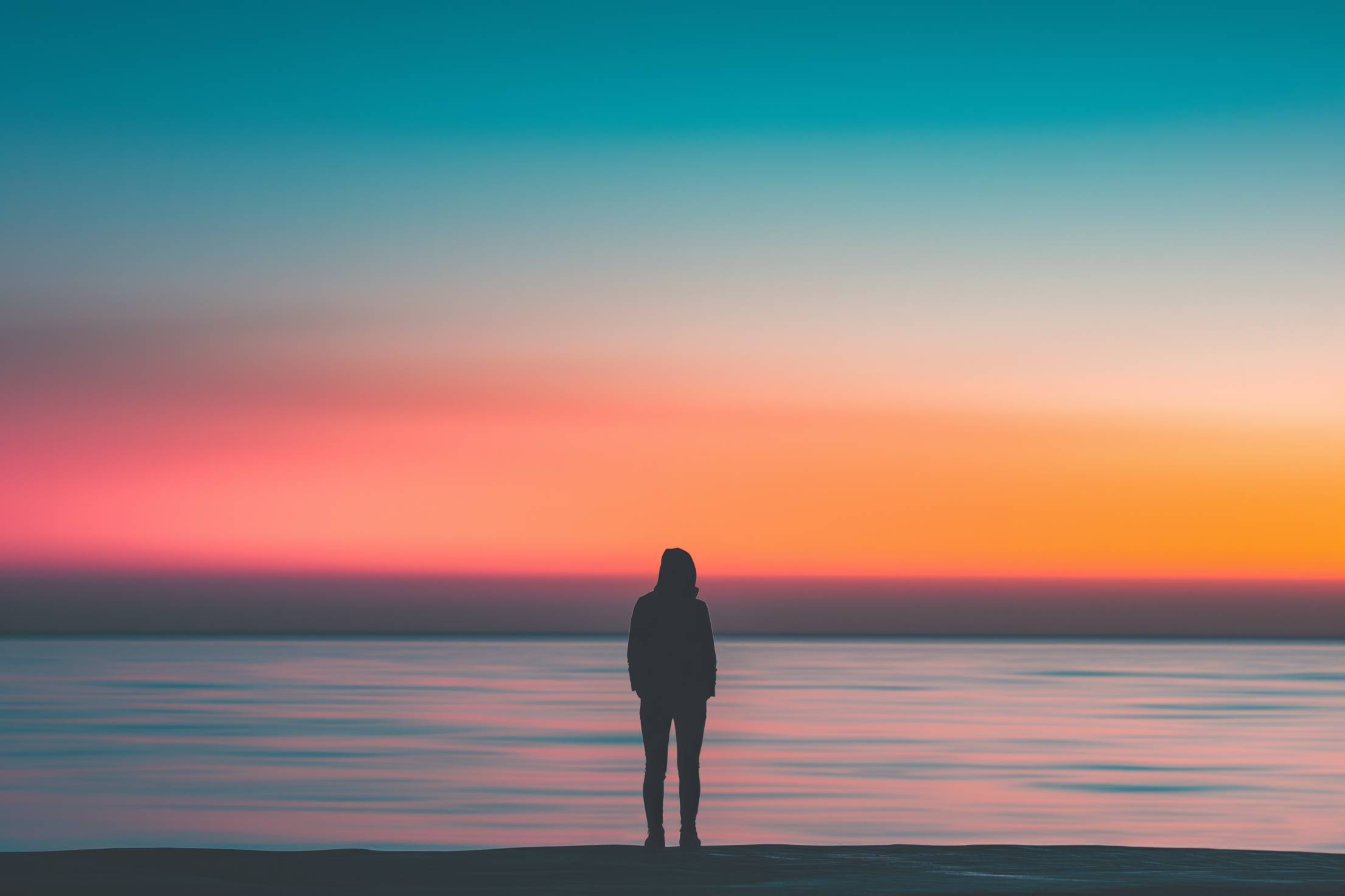 Long Exposure Photo of a Person After Sunset Over the Sea Stock Free